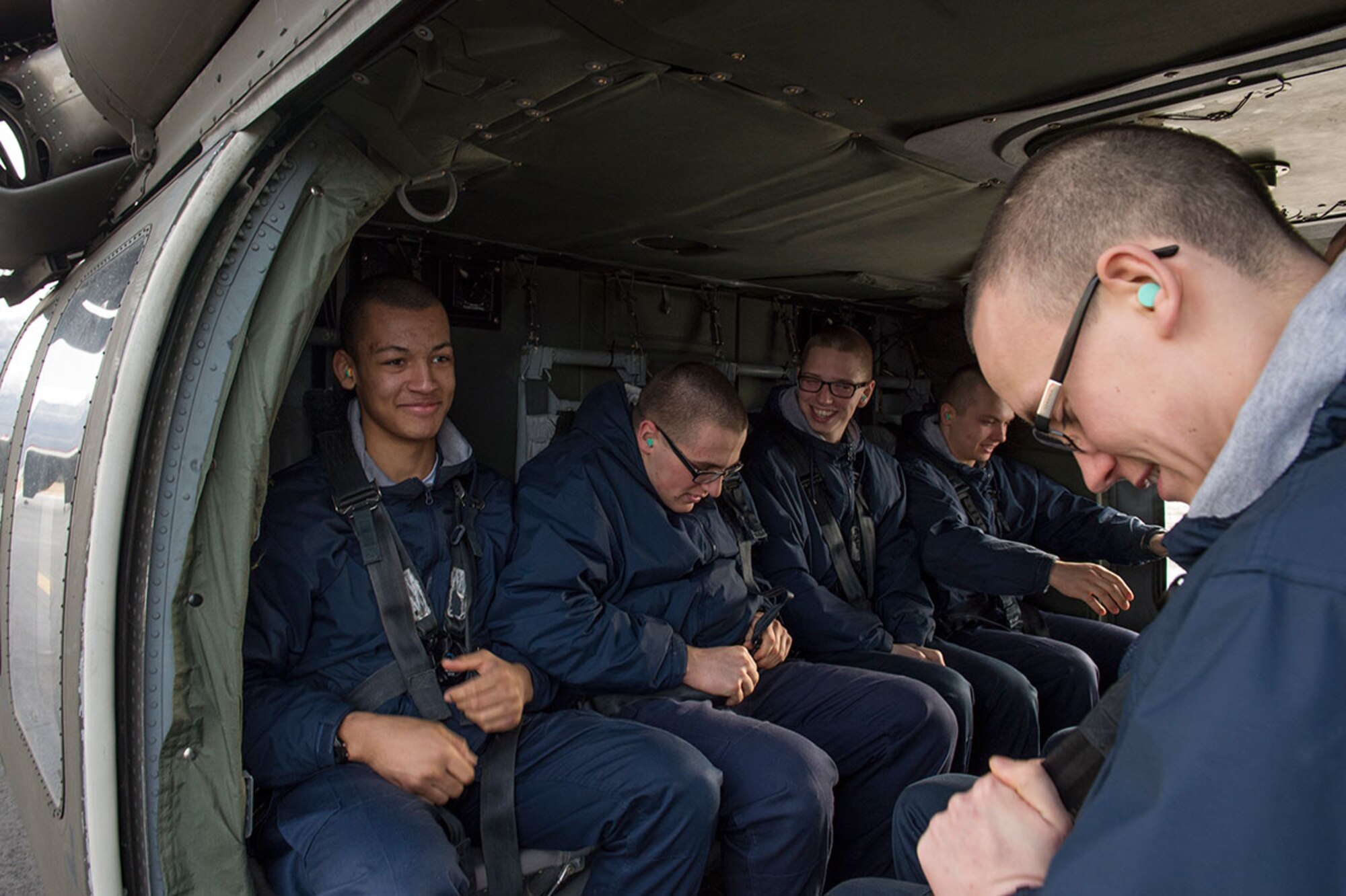 Alaska Military Youth Academy cadets secure themselves in an Alaska Army National Guard UH-60 Black Hawk helicopter assigned to 1st Battalion, 207th Aviation Regiment on Joint Base Elmendorf-Richardson, Alaska, Feb. 24, 2015. The Alaska Army National Guard participated in the AMYA outreach program to expose the cadets to military life. (U.S. Air Force photo/Alejandro Pena)