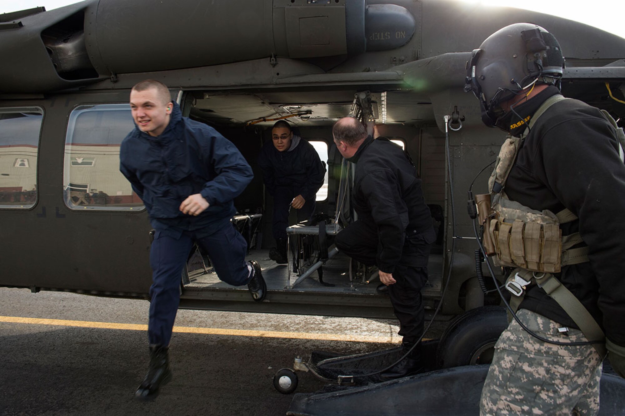 Alaska Military Youth Academy cadets exit an Alaska Army National Guard UH-60 Black Hawk helicopter assigned to 1st Battalion, 207th Aviation Regiment on Joint Base Elmendorf-Richardson, Alaska, Feb. 24, 2015. The Alaska Army National Guard participated in the AMYA outreach program to expose the cadets to military life. (U.S. Air Force photo/Alejandro Pena)