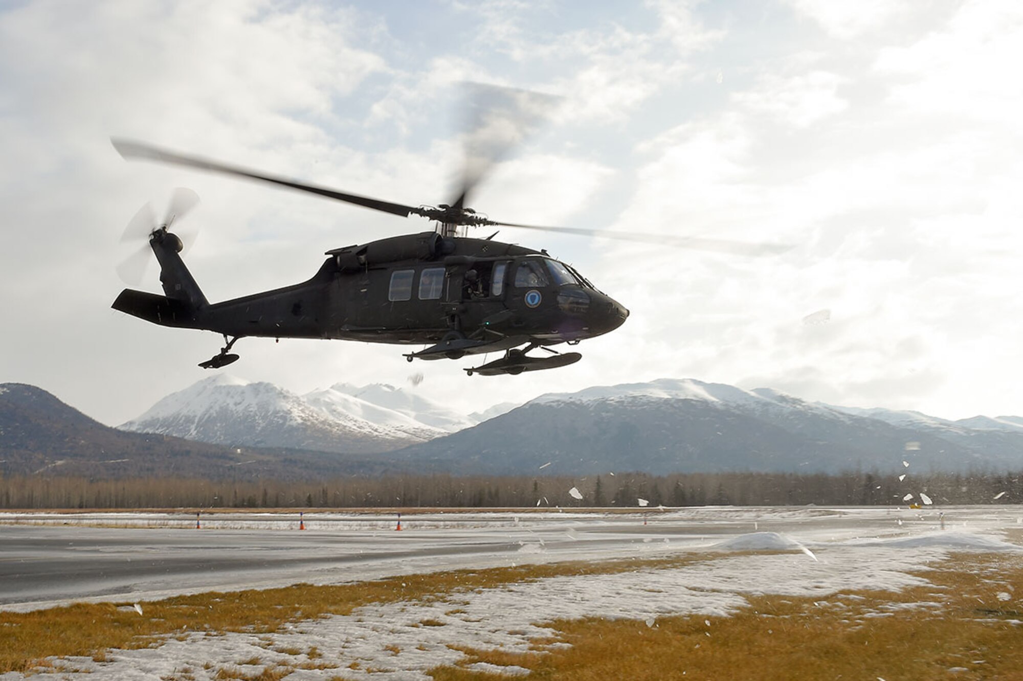 An Alaska Army National Guard UH-60 Black Hawk helicopter assigned to 1st Battalion, 507th Aviation Regiment, lifts off over Joint Base Elmendorf-Richardson, Alaska, Feb. 24, 2015. The Alaska Army National Guard participated in the Alaska Military Youth Academy outreach program to expose the cadets to military life. (U.S. Air Force photo/Alejandro Pena)