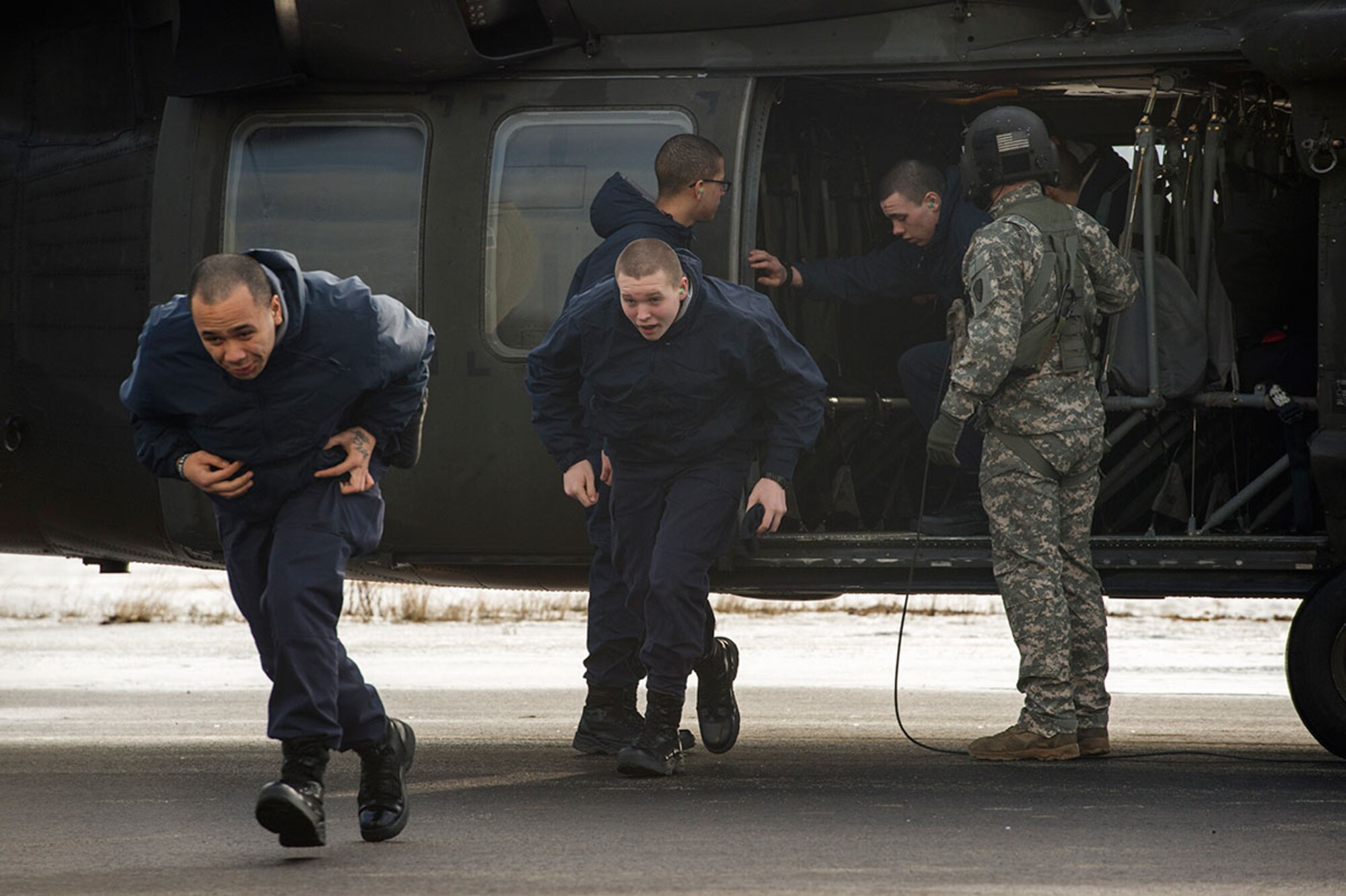 Alaska Military Youth Academy cadets exit an Alaska Army National Guard UH-60 Black Hawk helicopter assigned to 1st Battalion, 507th Aviation Regiment on Joint Base Elmendorf-Richardson, Alaska, Feb. 24, 2015. The Alaska Army National Guard participated in the AMYA outreach program to expose the cadets to military life. (U.S. Air Force photo/Alejandro Pena)
