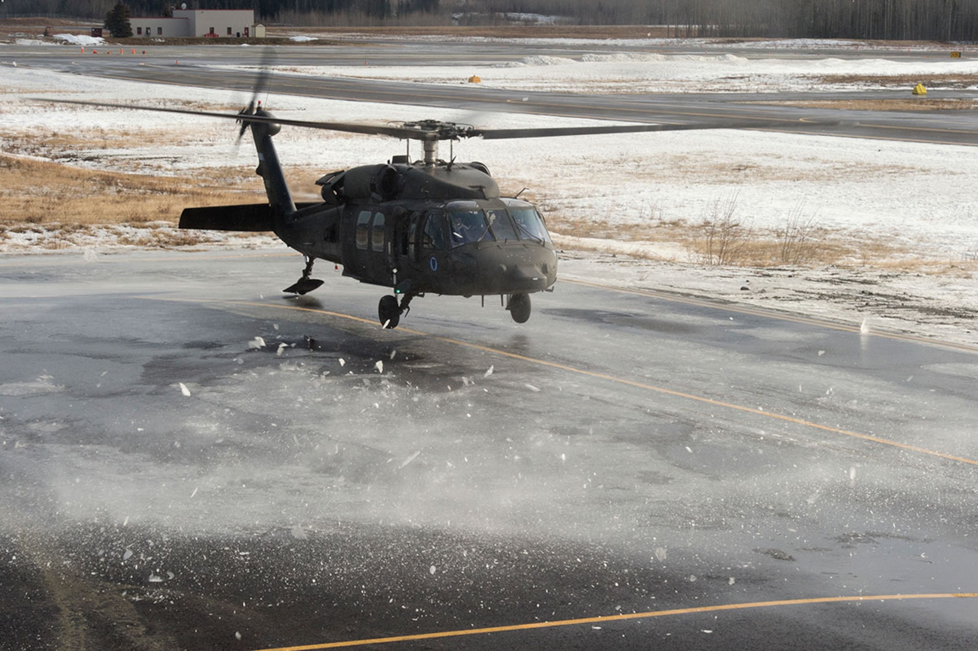 An Alaska Army National Guard UH-60 Black Hawk helicopter assigned to 1st Battalion, 507th Aviation Regiment, approaches a landing zone on Joint Base Elmendorf-Richardson, Alaska, Feb. 24, 2015. The Alaska Army National Guard participated in the Alaska Military Youth Academy outreach program to expose the cadets to military life. (U.S. Air Force photo/Alejandro Pena)