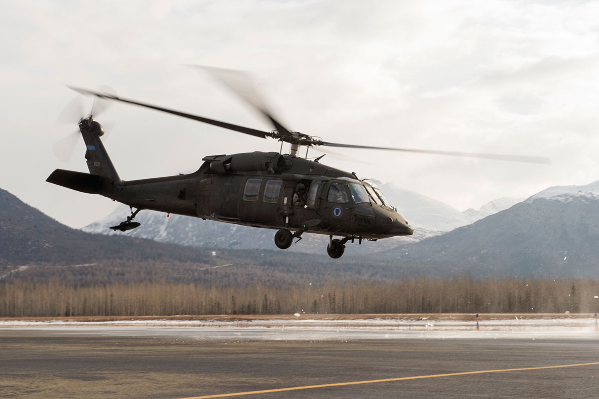 An Alaska Army National Guard UH-60 Black Hawk helicopter assigned to 1st Battalion, 507th Aviation Regiment, lifts off over Joint Base Elmendorf-Richardson, Alaska, Feb. 24, 2015. The Alaska Army National Guard participated in the Alaska Military Youth Academy outreach program to expose the cadets to military life. (U.S. Air Force photo/Alejandro Pena)