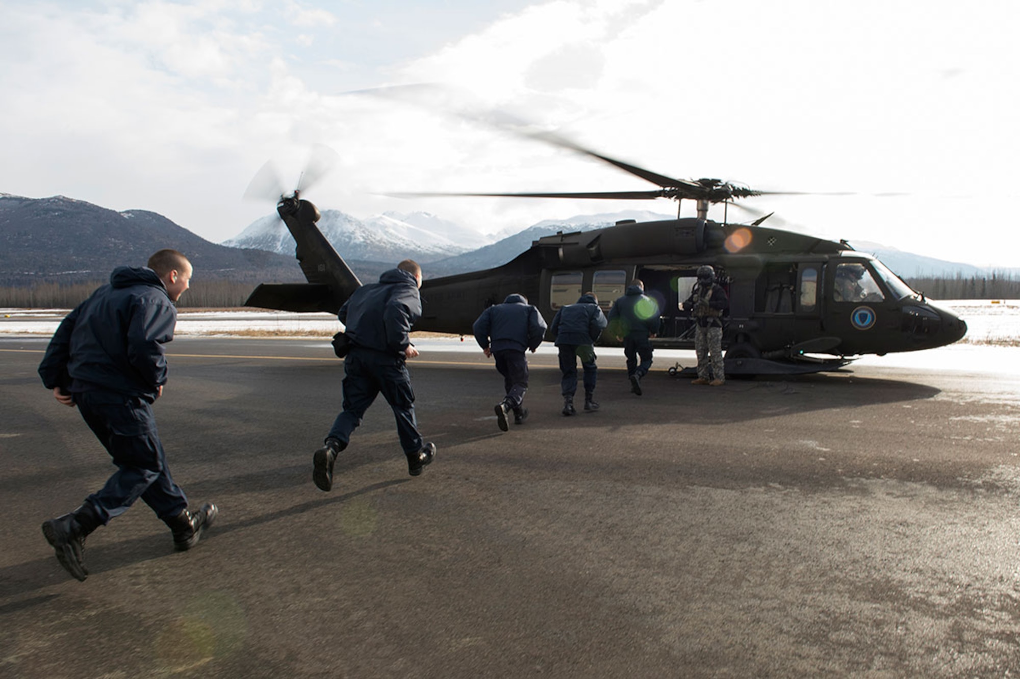 Alaska Military Youth Academy cadets board an Alaska Army National Guard UH-60 Black Hawk helicopter assigned to 1st Battalion, 507th Aviation Regiment on Joint Base Elmendorf-Richardson, Alaska, Feb. 24, 2015. The Alaska Army National Guard participated in the AMYA outreach program to expose the cadets to military life. (U.S. Air Force photo/Alejandro Pena)