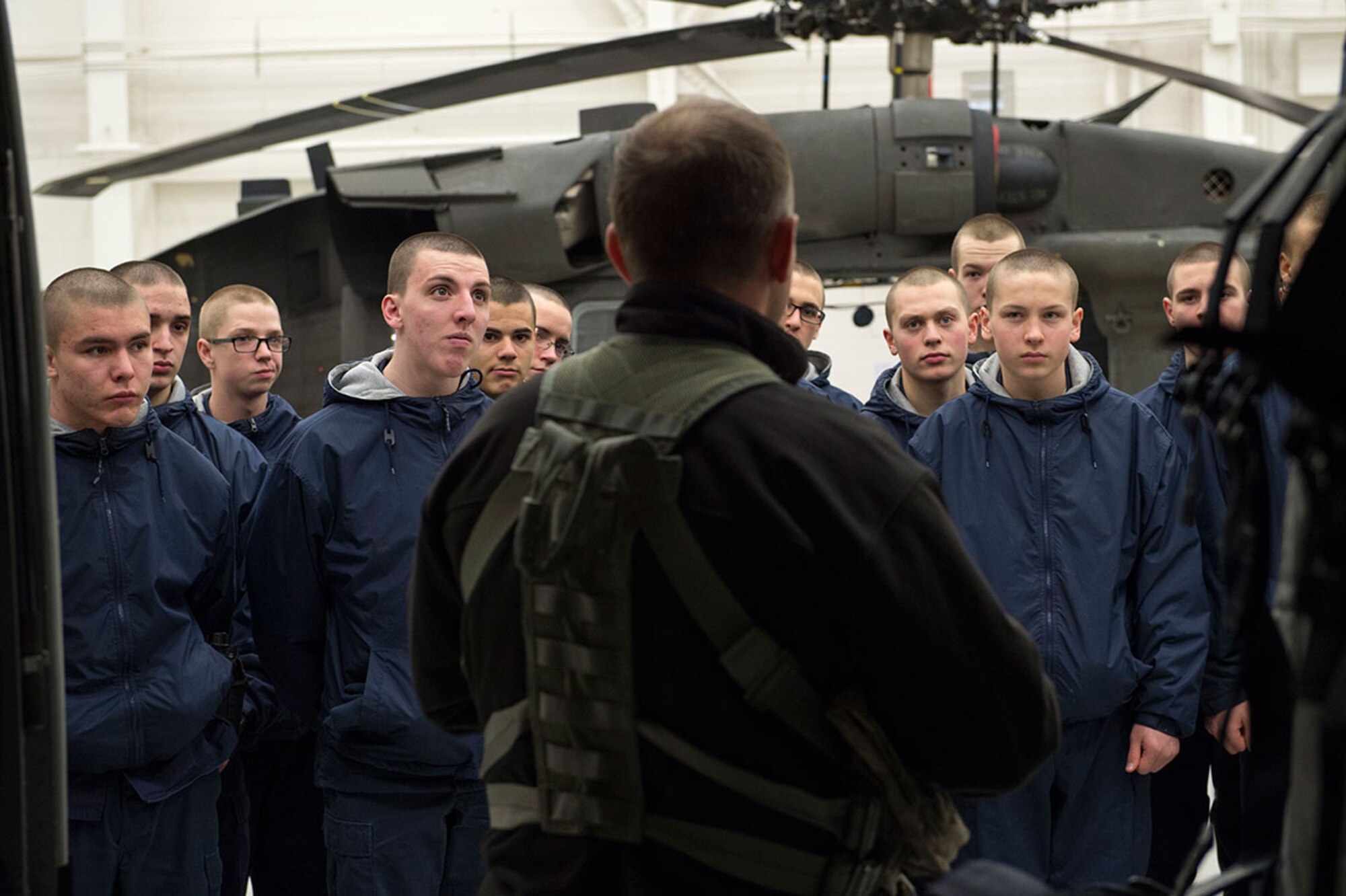 U.S. Army Sgt. 1st Class Thomas Stokesberry, a crew chief assigned to the Alaska Army National Guard, 1st Battalion, 507th Aviation Regiment, familiarizes cadets from the Alaska Military Youth Academy, with the UH-60 Black Hawk helicopter on Joint Base Elmendorf-Richardson, Alaska, Feb. 24, 2015. The Alaska Army National Guard participated in the AMYA outreach program to expose the cadets to military life. (U.S. Air Force photo/Alejandro Pena)