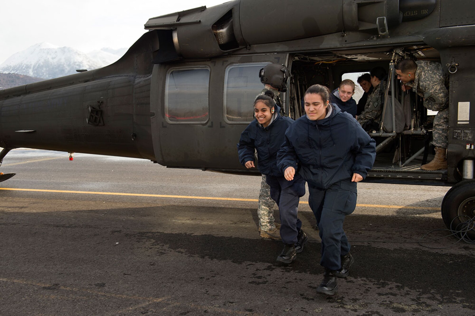 Alaska Military Youth Academy cadets exit an Alaska Army National Guard UH-60 Black Hawk helicopter assigned to 1st Battalion, 507th Aviation Regiment on Joint Base Elmendorf-Richardson, Alaska, Feb. 24, 2015. The Alaska Army National Guard participated in the AMYA outreach program to expose the cadets to military life. (U.S. Air Force photo/Alejandro Pena)