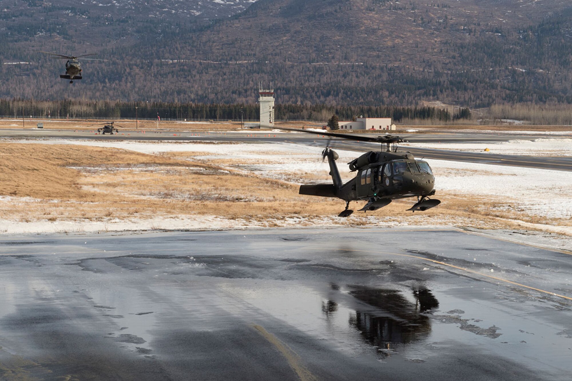 Two Alaska Army National Guard UH-60 Black Hawk helicopters assigned to 1st Battalion, 507th Aviation Regiment, approach a landing zone on Joint Base Elmendorf-Richardson, Alaska, Feb. 24, 2015. The Alaska Army National Guard participated in the Alaska Military Youth Academy outreach program to expose the cadets to military life. (U.S. Air Force photo/Alejandro Pena)