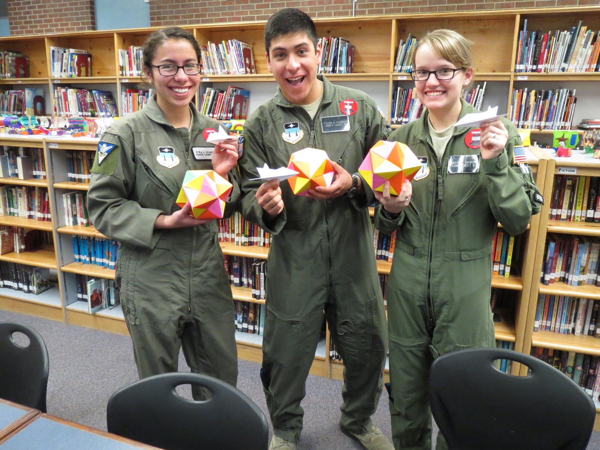 Cadet 3rd Class Kyra Schmidt (left), Cadet 2nd Class Tyler Hudson and Cadet 2nd Class Kaitlyn Sanborn, all members of the cadet-run STEM Club, hold the origami they made with students from the Classic Academy in Colorado Springs, Colo., Feb. 19, 2015. The cadets were invited to attend to help explain how origami relates to STEM subjects like engineering. (Courtesy photo)

