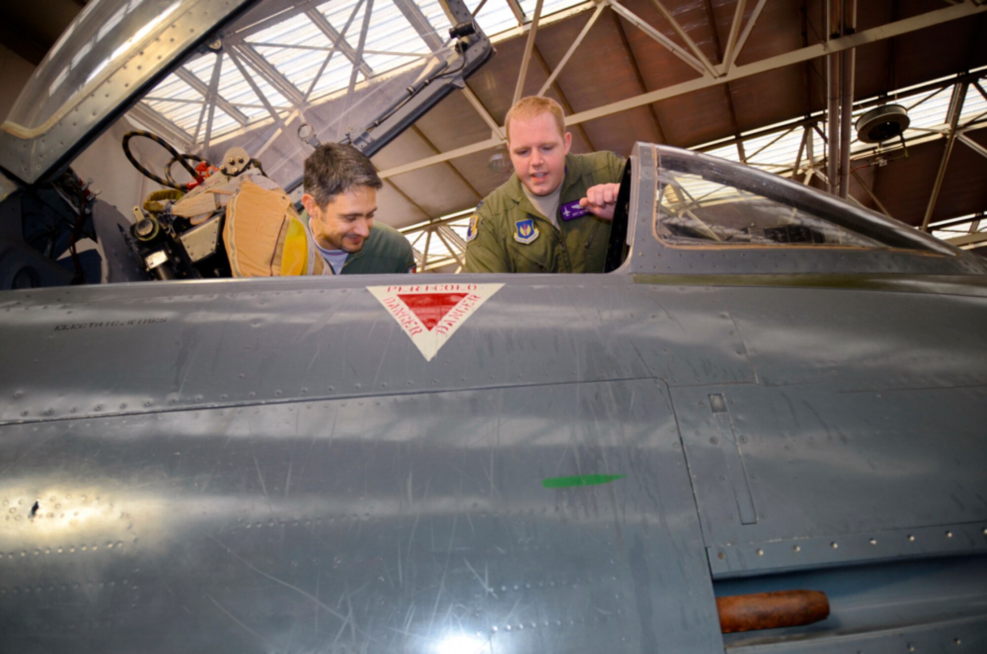 U.S. Air Force Capt. Matthew Wetherbee, 510th Fighter Squadron F-16 Fighting Falcon pilot, interacts with Tenente Colonnello (Lt. Col.) Rudy Barassi, former Italian air force aerobatic team member and F-16 pilot, during a speaking event in Udine, Italy, March 5, 2015. The event was planned to educate, motivate and inspire students at the Arturo Malignani aeronautical institution and build relations between American and Italian communities. (Arturo Malignani aeronautical institution courtesy photo)