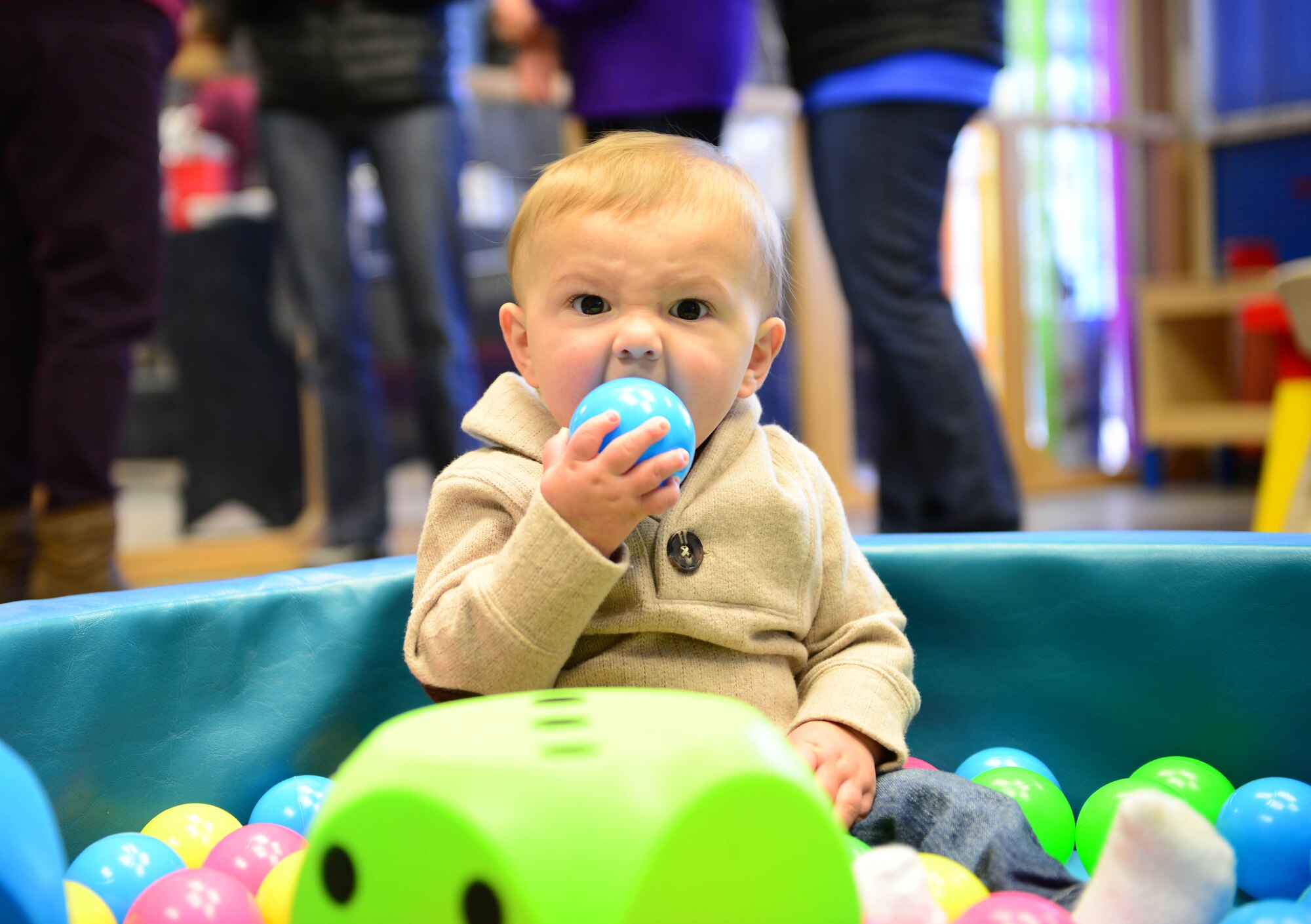 Cruze, child of Sean and Kayla Compton, plays in a ballpit during the grand opening of Café de Crayons, March 5, 2015, at Aviano Air Base, Italy. Café de Crayon, a new room inside the Aviano Community Center, gives children a safe environment to play while parents enjoy time with other spouses. (U.S. Air Force photo by Senior Airman Matthew Lotz/Released)