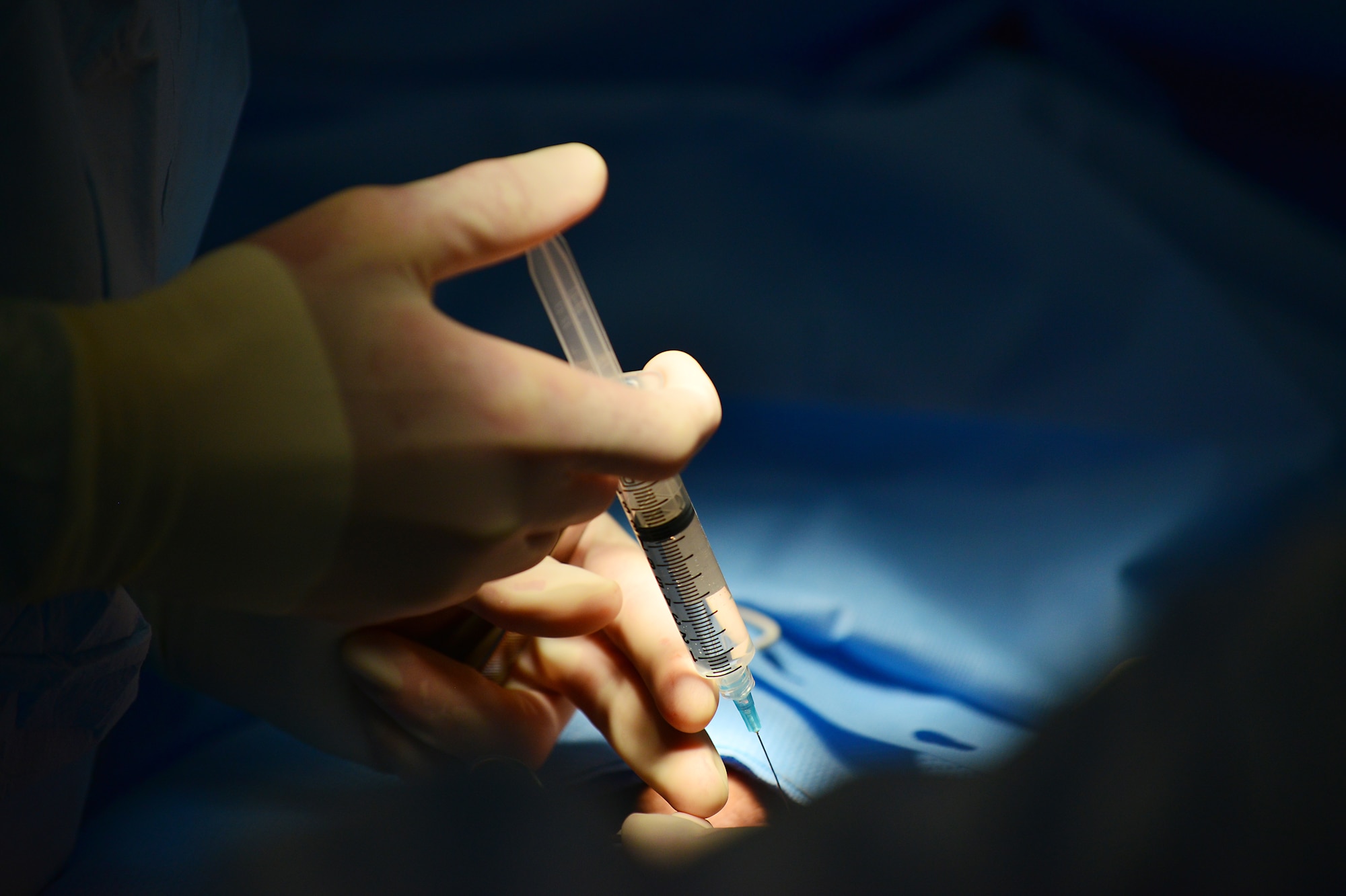 U.S. Air Force Maj. Alicia Capps, 31st Surgical Operations Squadron physician’s assistant, injects an anesthetic into a patient during surgery, March 4, 2015, at Aviano Air Base, Italy. The surgical team performs a variety of different routine surgeries, such as cesarean-sections, vasectomies, gall bladder removal, benign mass removal, orthopedics and biopsies for cancer. (U.S. Air Force photo by Airman 1st Class Ryan Conroy/Released) 