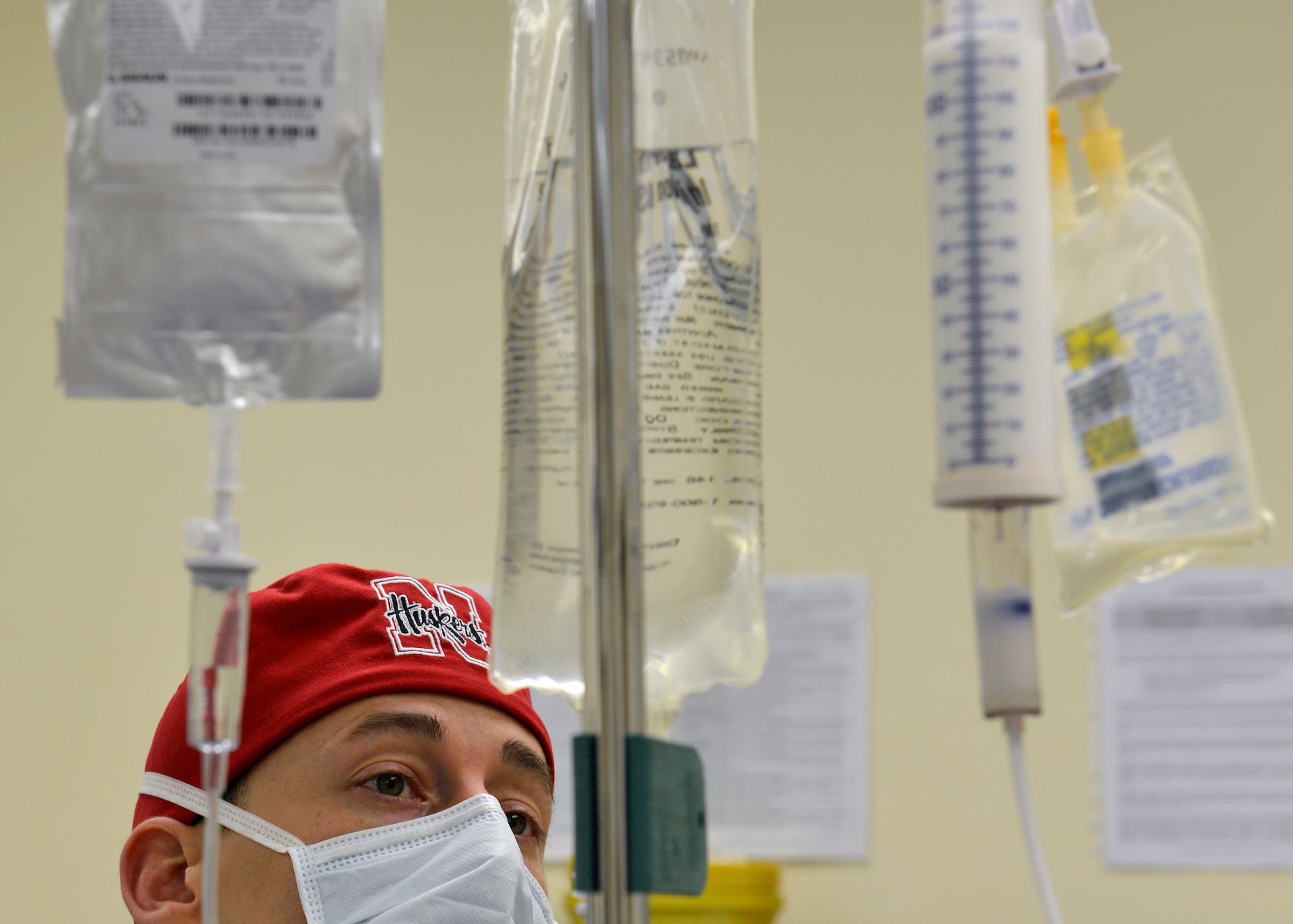 U.S. Air Force Capt. Sean Bancroft, 31st Surgical Operations Squadron certified registered nurse anesthetist, observes a patient’s intravenous drip during a surgery, March 4, 2015, at Aviano Air Base, Italy. A CRNA is responsible for administering anesthetic agents to patients and monitoring their reactions to the anesthesia and surgery. (U.S. Air Force photo by Airman 1st Class Ryan Conroy/Released)  