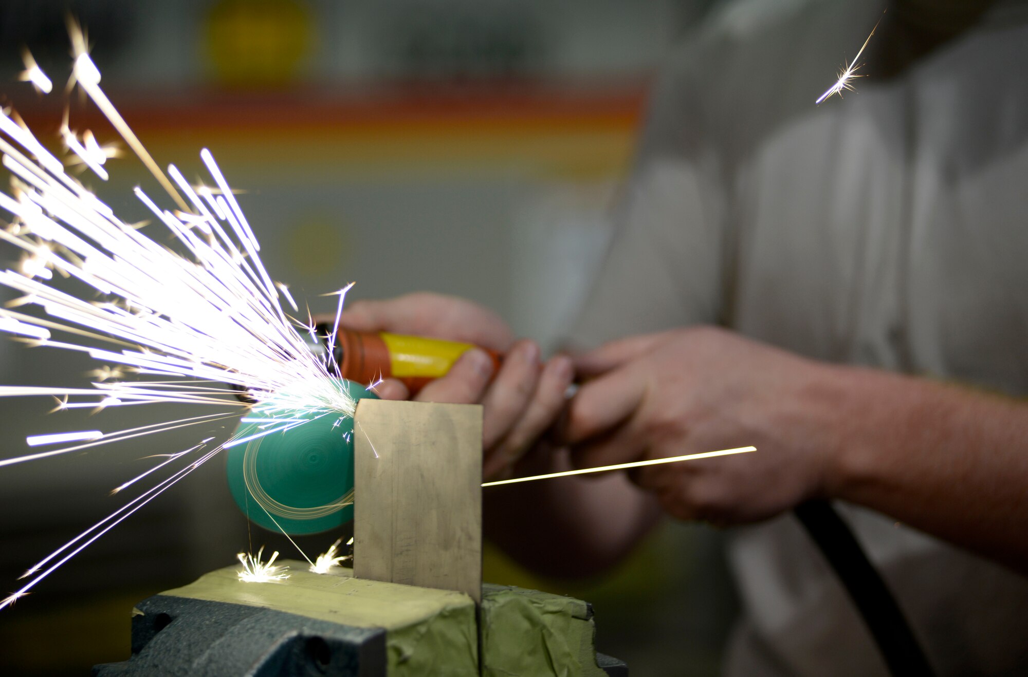 U.S. Air Force Tech. Sgt. Jeremy Ryan, 31st Maintenance Squadron aircraft structural maintenance craftsman, trims titanium, March 4, 2015 at Aviano Air Base, Italy. Aircraft structural maintenance Airmen perform fabrication, structural repairs and modifications for aircraft. (U.S. Air Force photo by Senior Airman Areca T. Wilson/Released)