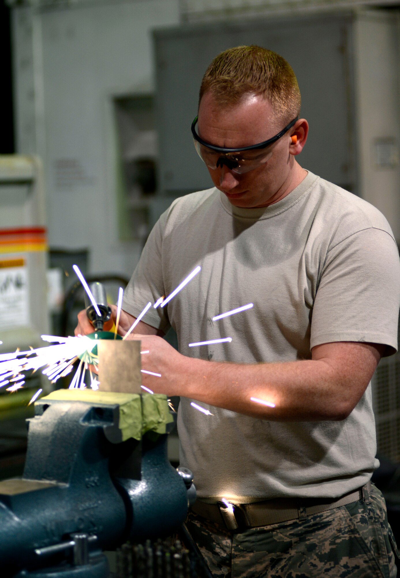 U.S. Air Force Tech. Sgt. Jeremy Ryan, 31st Maintenance Squadron aircraft structural maintenance craftsman, trims titanium, March 4, 2015 at Aviano Air Base, Italy. Aircraft structural maintenance Airmen replace hardware parts and repair aircraft frames. (U.S. Air Force photo by Senior Airman Areca T. Wilson/Released)