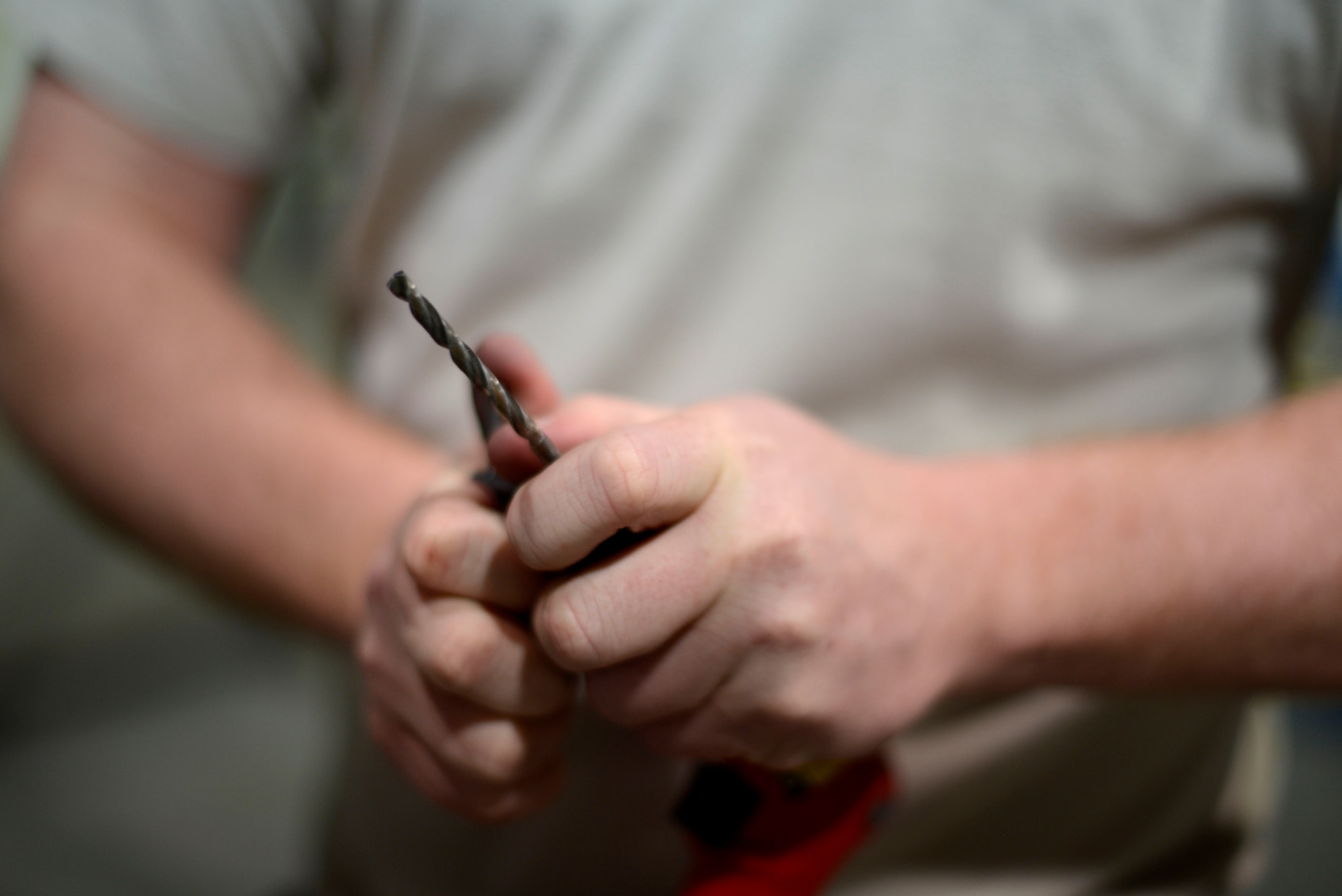 U.S. Air Force Tech. Sgt. Jeremy Ryan, 31st Maintenance Squadron aircraft structural maintenance craftsman, prepares to drill an F-16 Fighting Falcon flap panel, March 4, 2015 at Aviano Air Base, Italy. Aircraft structural maintenance Airmen replace hardware parts and repair aircraft frames. (U.S. Air Force photo by Senior Airman Areca T. Wilson/Released)
