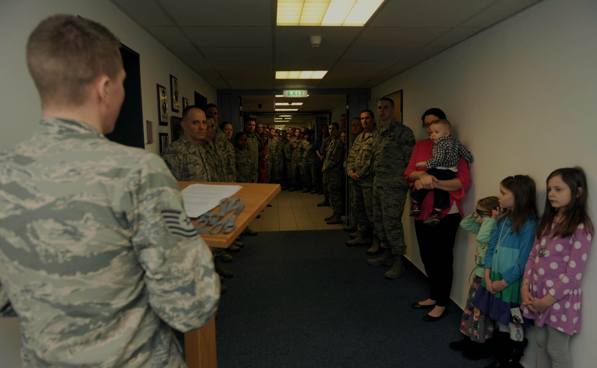 U.S. Air Force Tech. Sgt. Kalob Hinners, a Pitsenbarger Airman Leadership School instructor, left, speaks during the Pitsenbarger Heritage Room ribbon-cutting ceremony in the Pitsenbarger Airman Leadership School at Spangdahlem Air Base, Germany, March 4, 2015. Various members of the Spangdahlem community, including the 52nd Fighter Wing vice commander, Hinners’ family, ALS staff and students, attended the ceremony. (U.S. Air Force photo by Airman 1st Class Timothy Kim/Released)