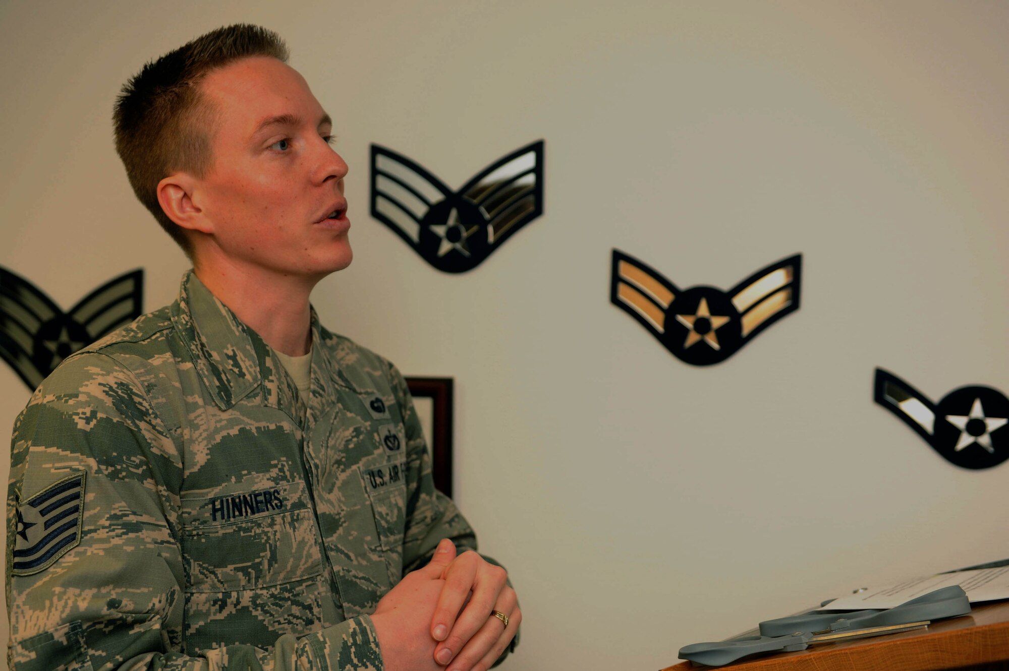 U.S. Air Force Tech. Sgt. Kalob Hinners, a Pitsenbarger Airman Leadership School instructor, gives a speech during the Pitsenbarger Heritage Room ribbon-cutting ceremony in the Pitsenbarger ALS at Spangdahlem Air Base, Germany, March 4, 2015. Hinners headed the conception, planning and construction of the heritage room with the aid of ALS staff and students. (U.S. Air Force photo by Airman 1st Class Timothy Kim/Released)