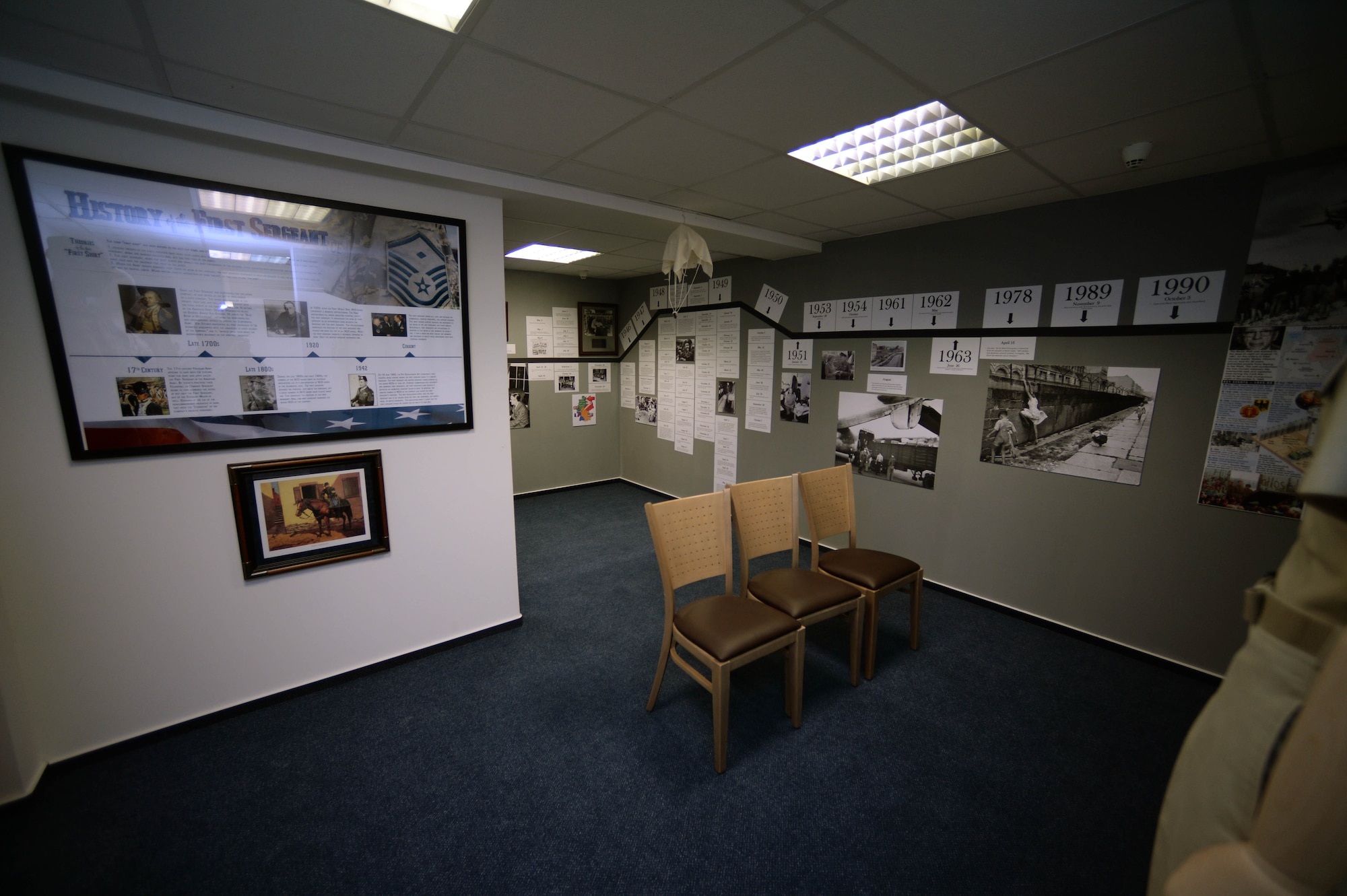 Various U.S. Air Force graphics remain on display in the Pitsenbarger Heritage Room in the Pitsenbarger Airman Leadership School at Spangdahlem Air Base, Germany, March 4, 2015. The school named the room in honor of U.S. Air Force Airman 1st Class William Pitsenbarger, the first enlisted Airman to be posthumously awarded the Air Force Cross medal in 1966, which was later upgraded to the Medal of Honor in 2000. (U.S. Air Force photo by Airman 1st Class Timothy Kim/Released)