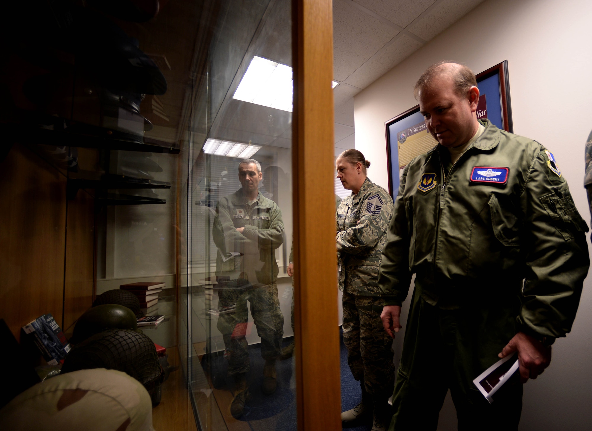 U.S. Air Force Col. Lars Hubert, 52nd Fighter Wing vice commander, looks at a display case while touring the Pitsenbarger Heritage Room after its ribbon-cutting ceremony in the Pitsenbarger Airman Leadership School at Spangdahlem Air Base, Germany, March 4, 2015. The room opened for viewing and tours upon the completion of the ribbon-cutting ceremony and contained various displays in remembrance of U.S. Air Force heritage and history. (U.S. Air Force photo by Airman 1st Class Timothy Kim/Released)