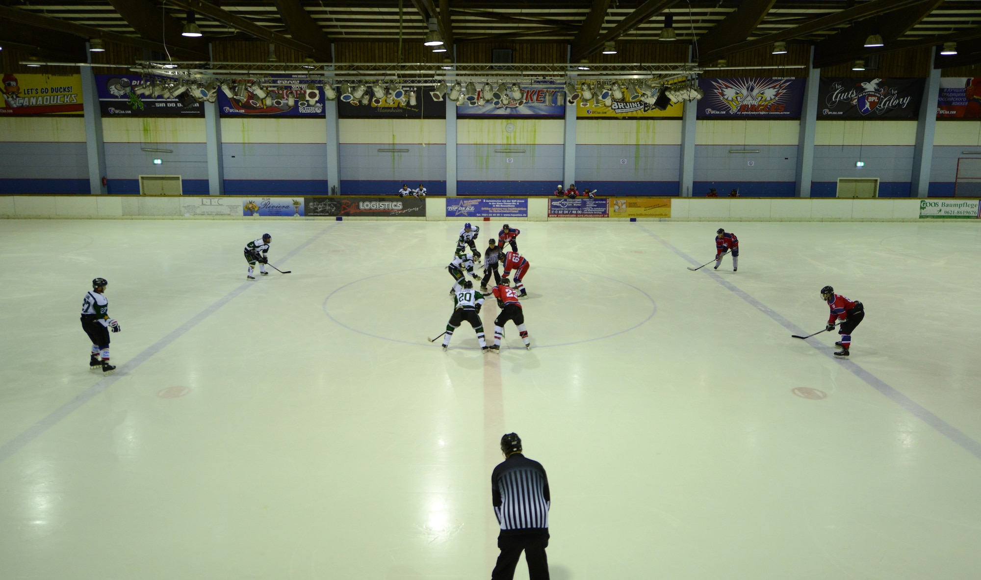 The referee drops the puck for the first play during a hockey game between the Kaiserslautern Military Community Eagles 1 and the Export Rangers in Viernheim, Germany, Feb. 25, 2015. The Eagles 1 were named the 23rd annual Armed Forces Alpine Classic Division I Champions during a tournament in Garmisch, Germany. (U.S. Air Force photo/A1C Tryphena Mayhugh)