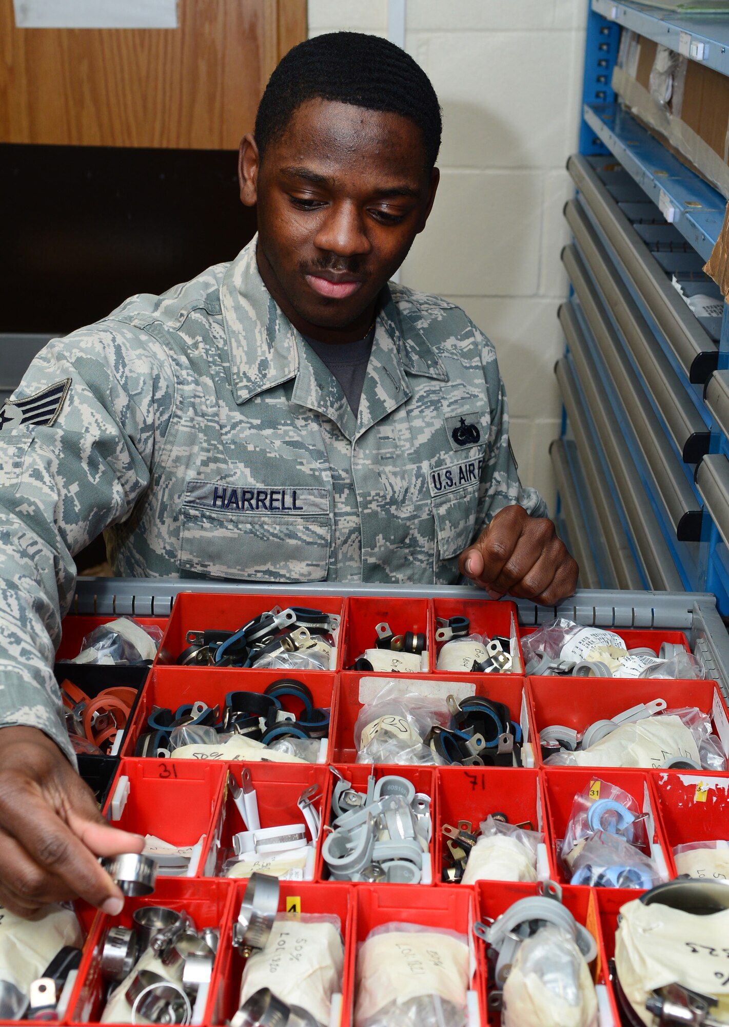 U.S. Air Force Staff Sgt. DeAlex Harrell, 100th Logistics Readiness Squadron KC-135 Weapons System Fusion Cell iscochronal/hourly post-flight inspection supervisor from St. Pauls, N.C., ensures all required benchstock items are on hand Feb. 6, 2015, on RAF Mildenhall, England. Harrell orders and oversees benchstock items for isochronal purposes, and works hand in hand with isochronal tool crib benchstock monitors. (U.S. Air Force photo by Karen Abeyasekere/Released)