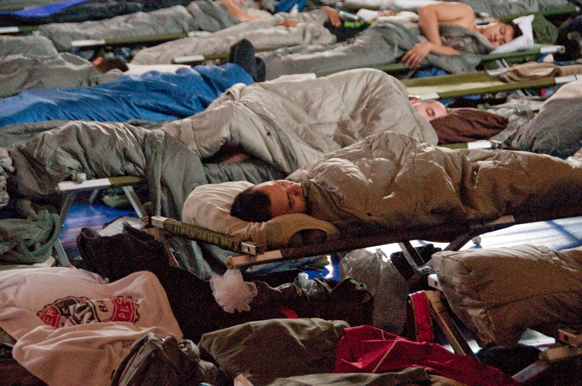 U.S. service members temporarily assigned to Osan Air Base, Republic of Korea, in support of  exercise Key Resolve sleep at the Osan Fitness and Sports Complex on March 2, 2015. The Key Resolve exercise is an annual training event designed to ensure readiness to defend the Republic of Korea and sustain the capabilities that strengthen the ROK-U.S. Alliance. (U.S. Air Force photo by Staff Sgt. William Banton/Released)