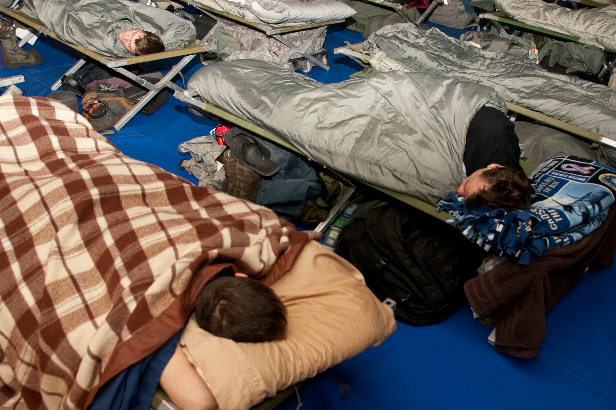 U.S. service members temporarily assigned to Osan Air Base, Republic of Korea, in support of  exercise Key Resolve sleep at the Osan Fitness and Sports Complex on March 2, 2015. The Key Resolve exercise is an annual training event designed to ensure readiness to defend the Republic of Korea and sustain the capabilities that strengthen the ROK-U.S. Alliance. (U.S. Air Force photo by Staff Sgt. William Banton/Released)