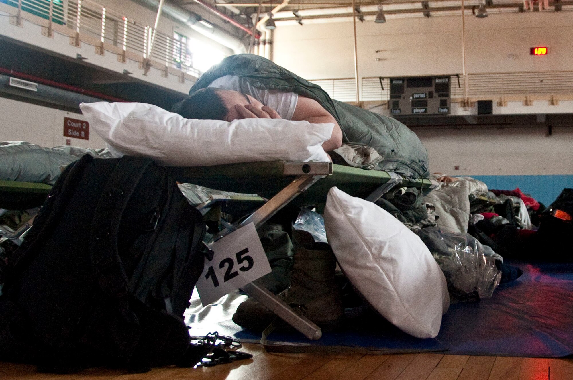 A U.S. service member temporarily assigned to Osan Air Base, Republic of Korea, in support of  exercise Key Resolve sleeps at the Osan Fitness and Sports Complex on March 2, 2015. The Key Resolve exercise is an annual training event designed to ensure readiness to defend the Republic of Korea and sustain the capabilities that strengthen the ROK-U.S. Alliance. (U.S. Air Force photo by Staff Sgt. William Banton/Released)