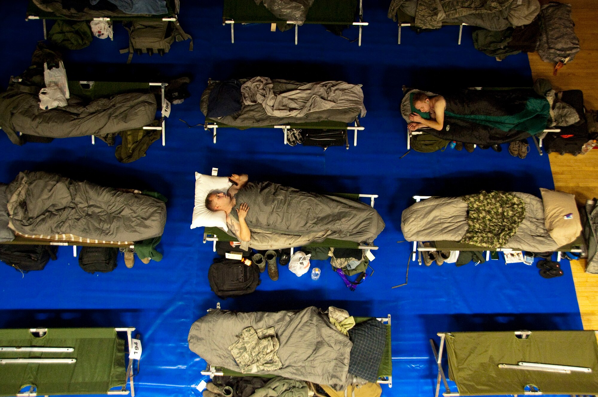 U.S. service members temporarily assigned to Osan Air Base, Republic of Korea, in support of  exercise Key Resolve sleep at the Osan Fitness and Sports Complex on March 2, 2015. The Key Resolve exercise is an annual training event designed to ensure readiness to defend the Republic of Korea and sustain the capabilities that strengthen the ROK-U.S. Alliance. (U.S. Air Force photo by Staff Sgt. William Banton/Released)