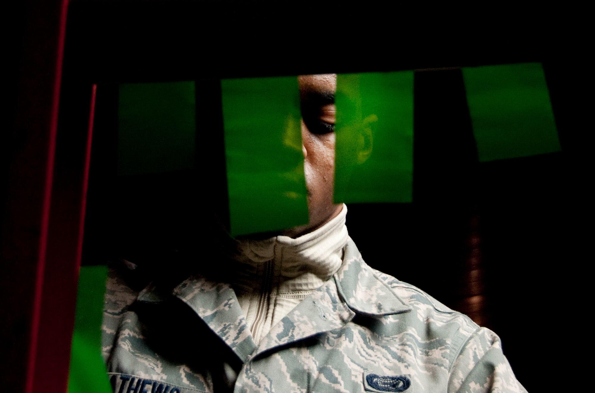 U.S. Air Force Senior Airman David Mathews, a 51st Force Support Squadron (FSS) outbound assignment counselor, prepares tape to black out windows March 1, 2015, in the Osan Air Base, Republic of Korea, Fitness and Sports Complex as part of the bed down team during exercise Key Resolve. Bed down is the process during contingency operations where FSS facilitates lodging accommodations in gymnasiums and tents. (U.S. Air Force photo by Staff Sgt. William Banton/Released)