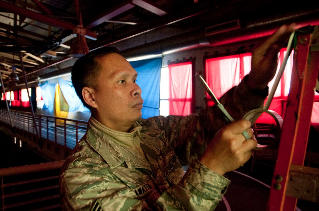 U.S. Air Force Staff Sgt. Apichet Worawattana, a 51st Force Support Squadron outbound assignments counselor, blacks out windows March 1, 2015, in the Osan Air Base, Republic of Korea, Fitness and Sports Complex as part of the bed down team during exercise Key Resolve. Bed down is the process during contingency operations where FSS facilitates lodging accommodations in gymnasiums and tents. (U.S. Air Force photo by Staff Sgt. William Banton/Released)