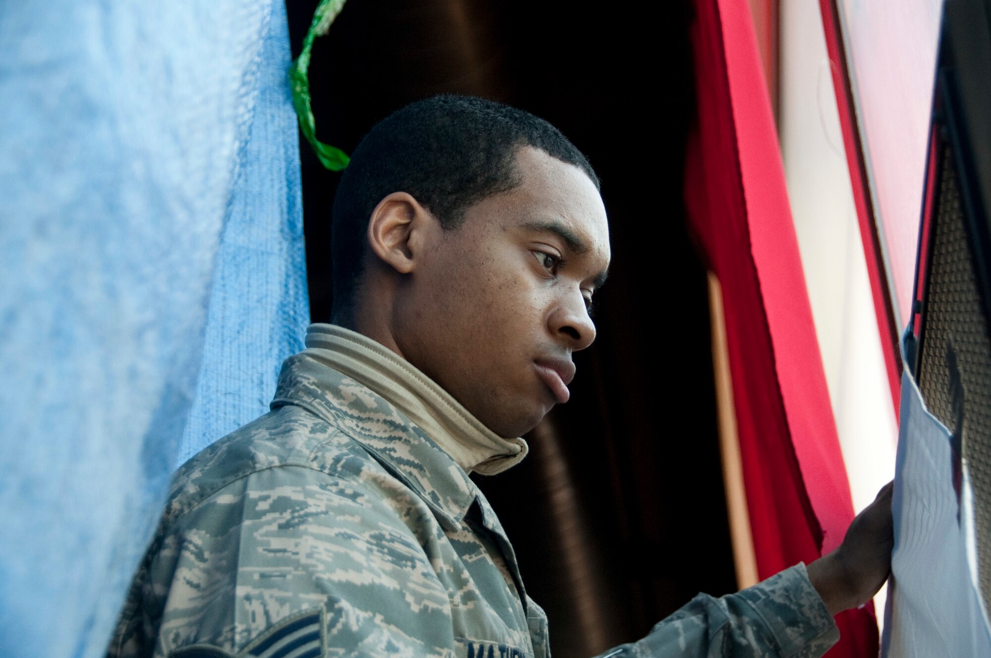 U.S. Air Force Senior Airman David Mathews, a 51st Force Support Squadron (FSS) outbound assignment counselor, blacks out windows March 1, 2015, in the Osan Air Base, Republic of Korea, Fitness and Sports Complex as part of the bed down team during exercise Key Resolve. Bed down is the process during contingency operations where FSS facilitates lodging accommodations in gymnasiums and tents. (U.S. Air Force photo by Staff Sgt. William Banton/Released)