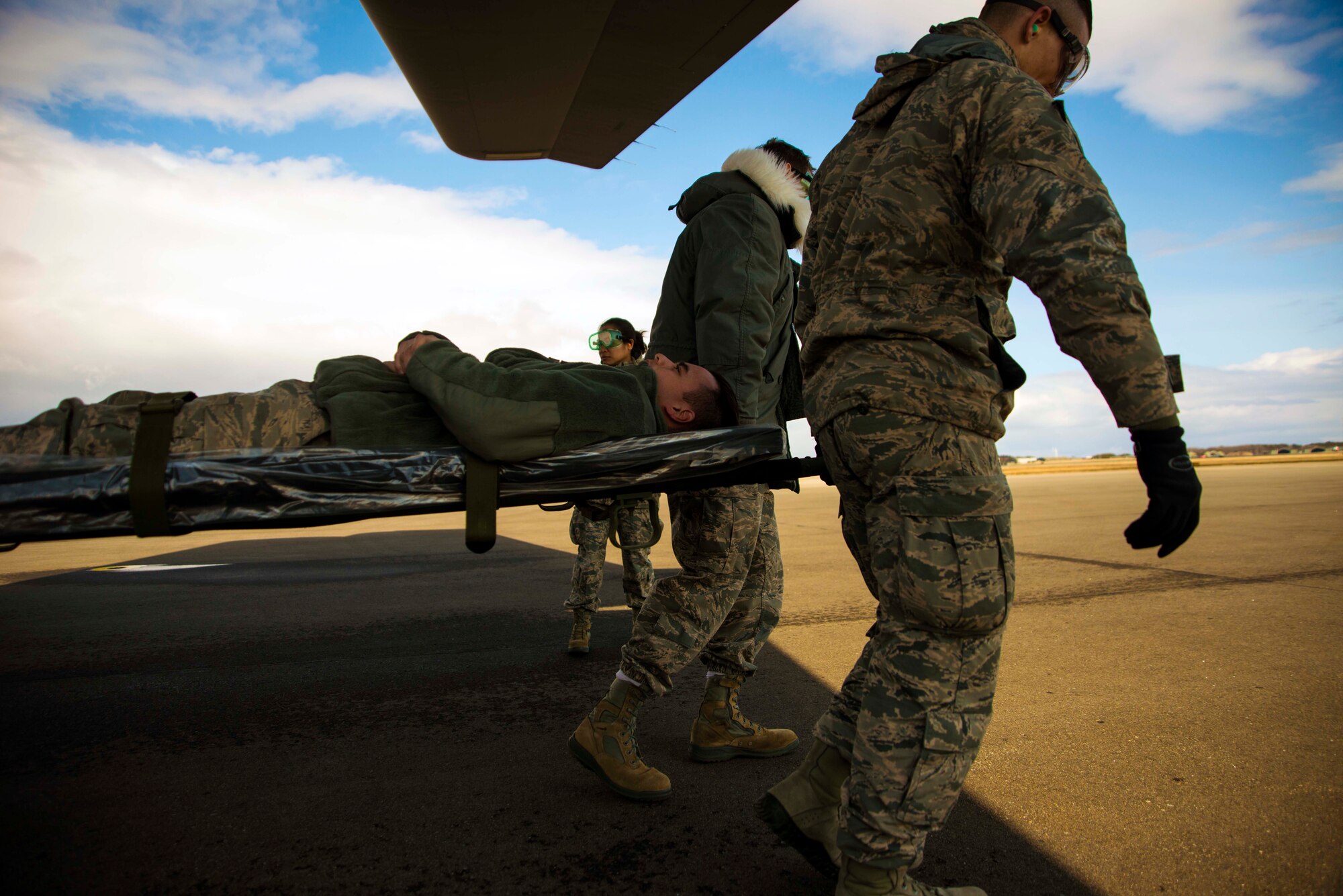 Airmen from the 35th Medical Group transport a patient from a C-130 Hercules during an aeromedical evacuation exercise March 5, 2015, at Misawa Air Base, Japan. The exercise was conducted in conjunction with Beverly Sunrise 15-2, an operational readiness exercise that deployed troops to and from Misawa and the Republic of Korea with the help of the California Air National Guard. (U.S. Air Force photo by Staff Sgt. Derek VanHorn/Released)
