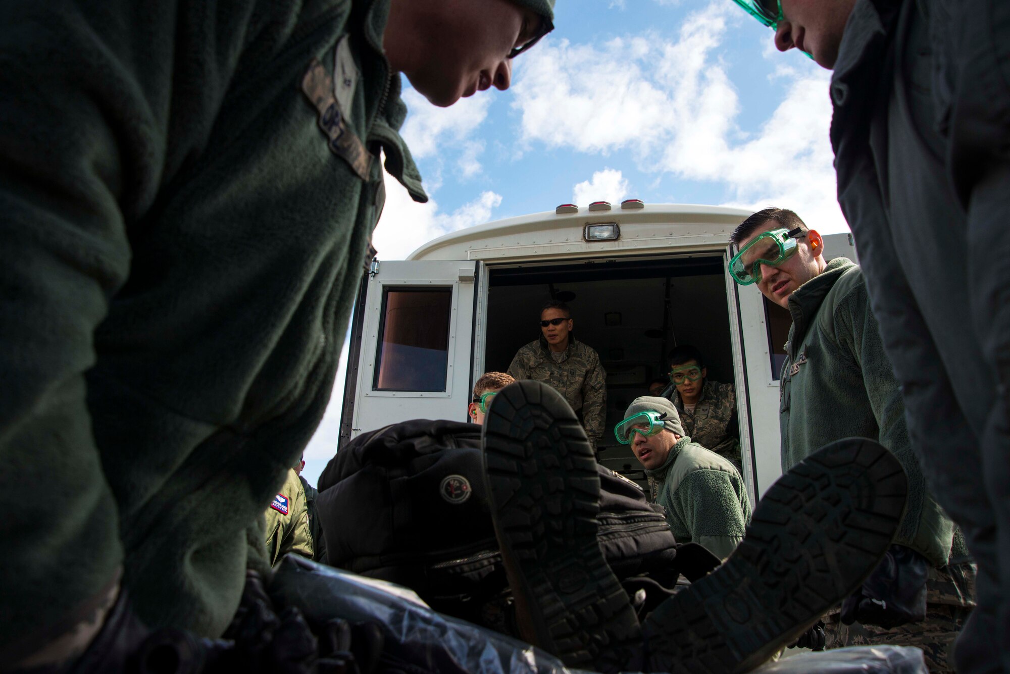 Airmen from the 35th Medical Group transport a patient from a C-130 Hercules onto a bus during an aeromedical evacuation exercise March 5, 2015, at Misawa Air Base, Japan. The exercise was conducted in conjunction with Beverly Sunrise 15-2, an operational readiness exercise that tested Airmen readiness in a variety of ways. The 35 MDG transported about 30 patients from the aircraft to the base hospital, where teams awaiting their arrival treated their injuries. (U.S. Air Force photo by Staff Sgt. Derek VanHorn/Released)
