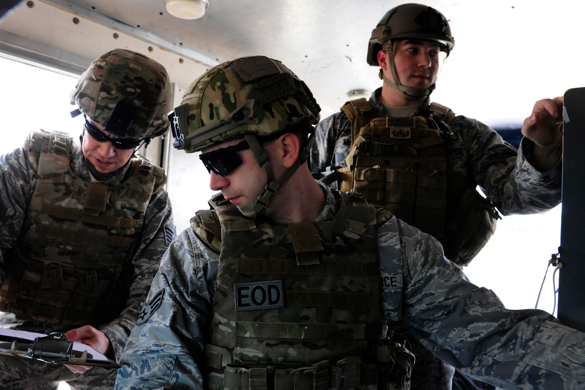 Tech. Sgt. Jason Bierman, 39th Civil Engineer Squadron explosive ordinance disposal team chief, and Senior Airmen Chad Barber and Nicholas McManuskolbay, 39th CES EOD technicians, work together to pilot an unmanned remote robot Feb. 25, 2015, at Incirlik Air Base, Turkey. The team used the robot to investigate a suspected bomb threat inside of a building during a base-wide exercise. (U.S. Air Force photo by Senior Airman Krystal Ardrey/Released)