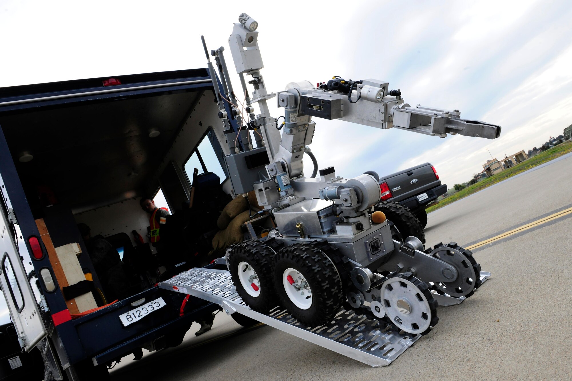 An unmanned remote robot is driven out of an explosive ordinance disposal vehicle Feb. 25, 2015, at Incirlik Air Base, Turkey. The robot, controlled by a 39th Civil Engineer Squadron EOD technician, is preparing to investigate a mock bomb threat during a base-wide exercise. (U.S. Air Force photo by Senior Airman Krystal Ardrey/Released)