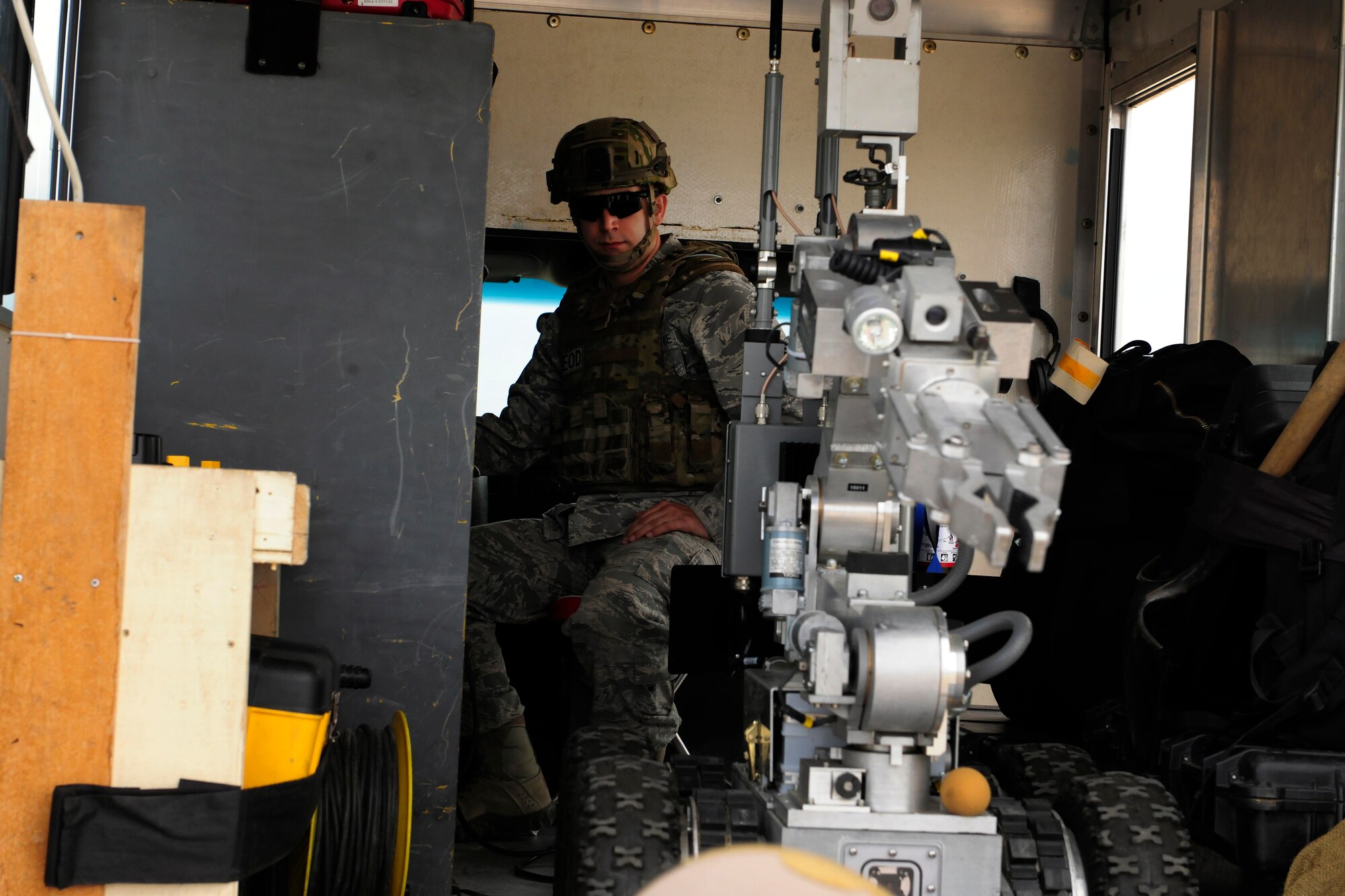 Senior Airman Chad Barber, 39th Civil Engineer Squadron explosive ordinance disposal technician, pilots an unmanned remote robot Feb. 25, 2015, at Incirlik Air Base, Turkey. Barber is part of a three Airmen team responding to a mock bomb threat during a base-wide exercise. (U.S. Air Force photo by Senior Airman Krystal Ardrey/Released)