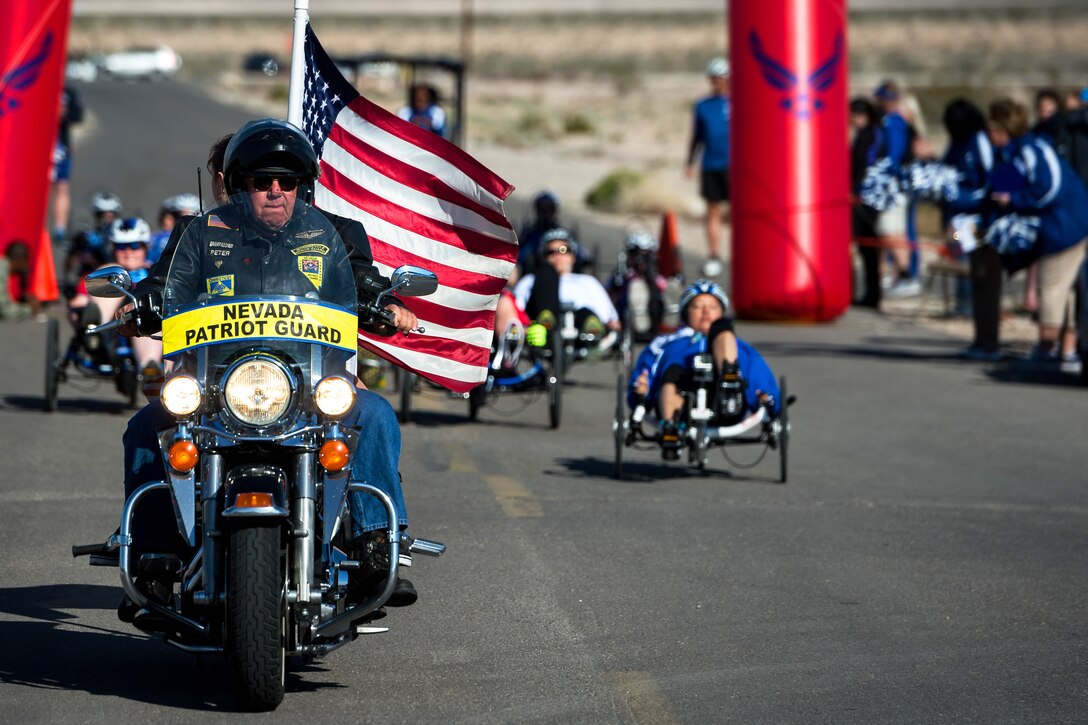 A Nevada Patriot Guard Rider paces wounded warrior cyclers during the Air Force trials on Nellis Air Force Base, Nev., Feb. 28, 2015. The trials are an adaptive sports event in preparation for the 2015 Warrior Games and are designed to promote the mental and physical well-being of seriously ill and injured military members and veterans.