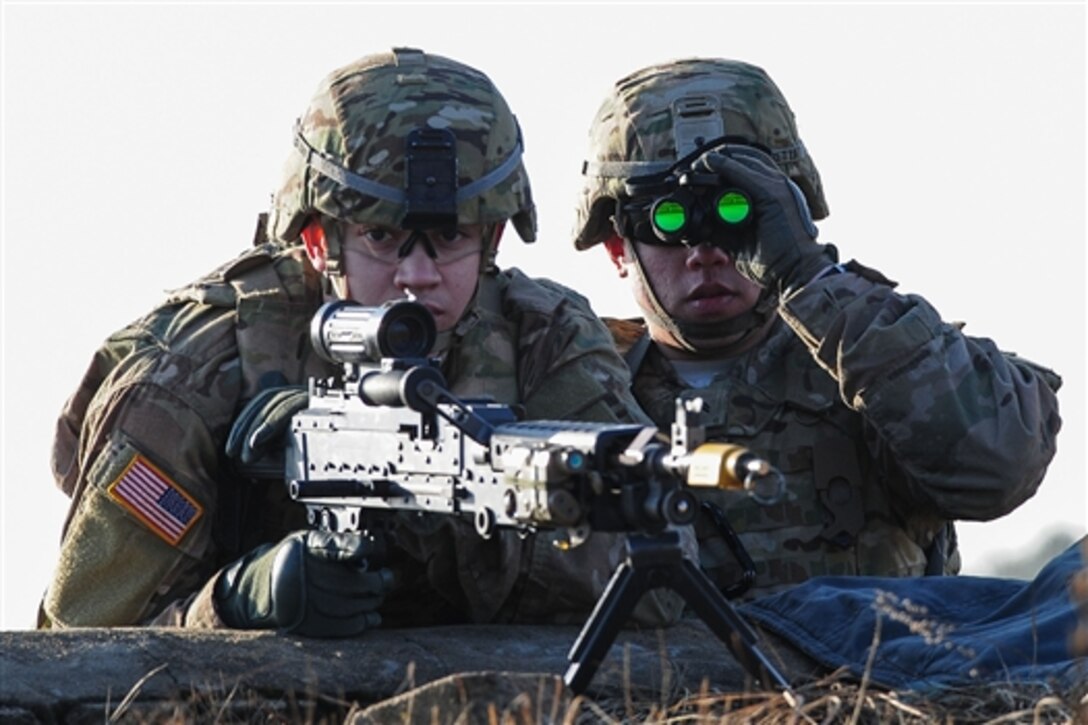 U.S. Army Pfc. Daniel J. Ackerman, left, and Cpl. Frank P. Perretta watch for enemy activity during a combined training exercise with Lithuanian troops as part of Operation Atlantic resolve in Pabrade training area, Lithuania, March 4, 2015. Operation Atlantic Resolve is a U.S. Army Europe-led land force assurance training mission taking place across Estonia, Latvia, Lithuania and Poland. 