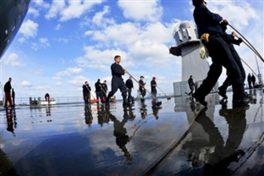 U.S. sailors use fresh water to wash the main deck of the USS Blue Ridge in the Pacific Ocean, March 3, 2015. The ship is conducting sea trials to prepare to resume patrols in the 7th Fleet area of responsibility. 