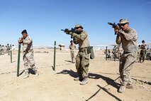 U.S. Marines and coalition forces with Task Force Al Asad teach Iraqi soldiers how to enter rooms using tape houses during Military Operations on Urban Terrain training aboard Al Asad Air Base, Iraq, Feb. 14-16, 2015. The three-day training period utilized different MOUT facilities in order to teach Iraqi soldiers basic room clearing techniques, how to move across linear danger areas as a squad, and the proper way to maneuver through a building in fire teams. (U.S. Marine Corps photo by Cpl. Tony Simmons/RELEASED)