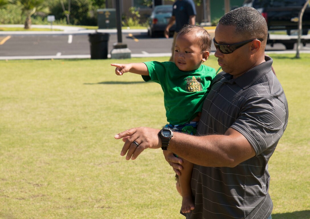 A child shows Sgt. Maj. Steven Collier, a Williamston, North Carolina, native, the football he wants Jan. 19 at The Homes at Ulu Wini Housing Project in Kona, Hawaii, Hawaii, during exercise Lava Viper 15.1-2. The Marines volunteered to go to the housing project to assist Hope Services Hawaii during their Martin Luther King clean-up day. Collier is the sergeant major of Marine Aircraft Group 24, 1st Marine Aircraft Wing, III Marine Expeditionary Force. 