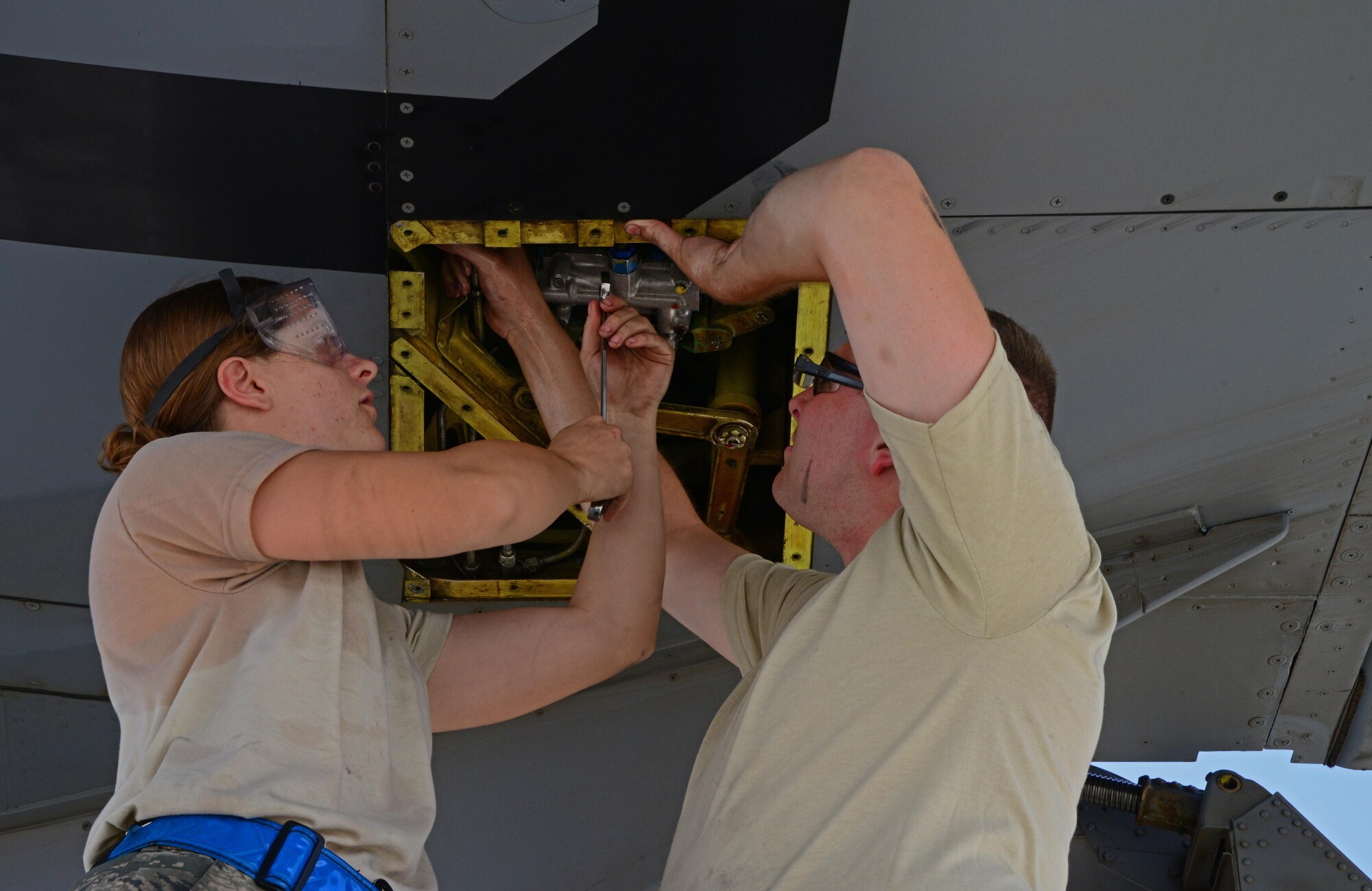 U.S. Air Force Senior Airmen Kara Quispez, left, and Michael Hoover, 340th Expeditionary Aircraft Maintenance Unit hydraulics mechanics, reseal the leading edge flap control valve on a KC-135 Stratotanker, March 3, 2015, at Al Udeid Air Base, Qatar. The KC-135’s air refueling capability reduces the risk and need for aircraft to land and refuel. (U.S. Air Force photo by Senior Airman Kia Atkins)