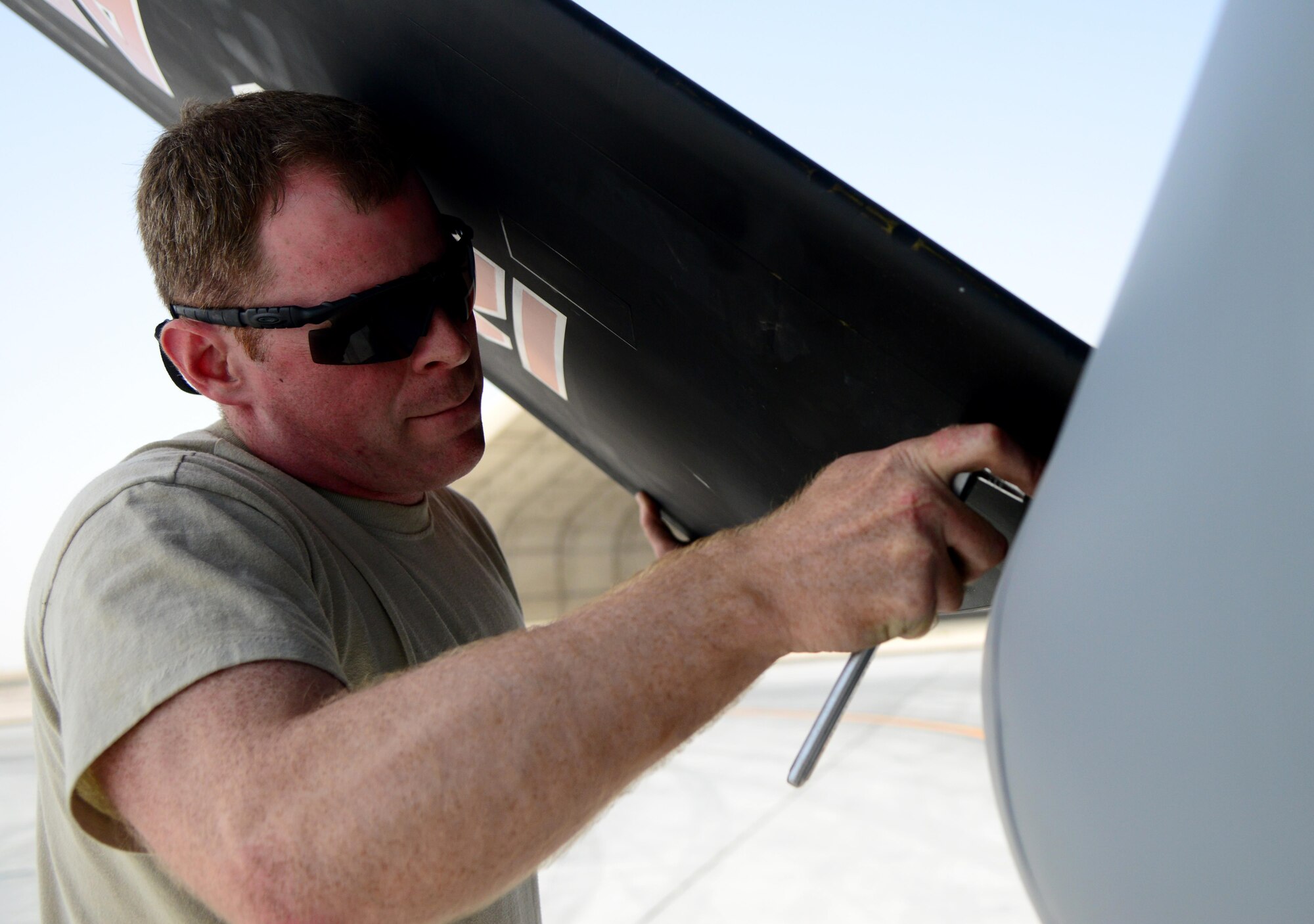 U.S. Air Force Staff Sgt. John Grimm, 340th Expeditionary Aircraft Maintenance Unit hydraulics specialist, takes off the ruddervator of a KC-135 Stratotanker, March 3, 2015, at Al Udeid Air Base, Qatar. The KC-135 can hold up to 200,000 lbs. of fuel and can double as a medical evacuation aircraft. (U.S. Air Force photo by Senior Airman Kia Atkins)