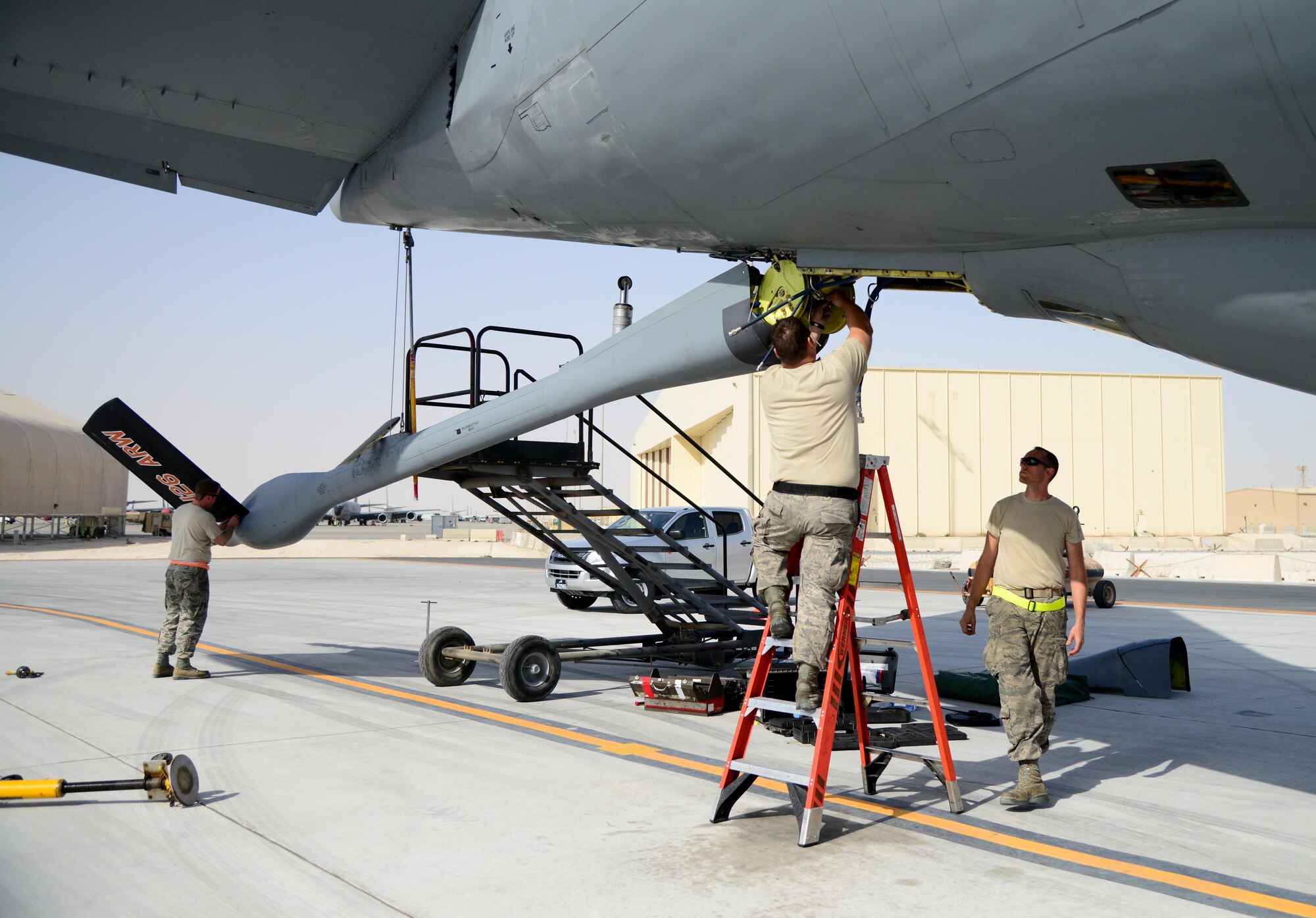Airmen from the 340th Expeditionary Aircraft Maintenance Unit perform maintenance on a KC-135 Stratotanker, March 3, 2015, at Al Udeid Air Base, Qatar. To support the  growing need for combat air power in the region,  in 2014, both the 340th Expeditionary Air Refueling Squadron  and 340th EAMU doubled in both number of aircraft and personnel—a feat that could not have been accomplished without total force integration. (U.S. Air Force photo by Senior Airman Kia Atkins)