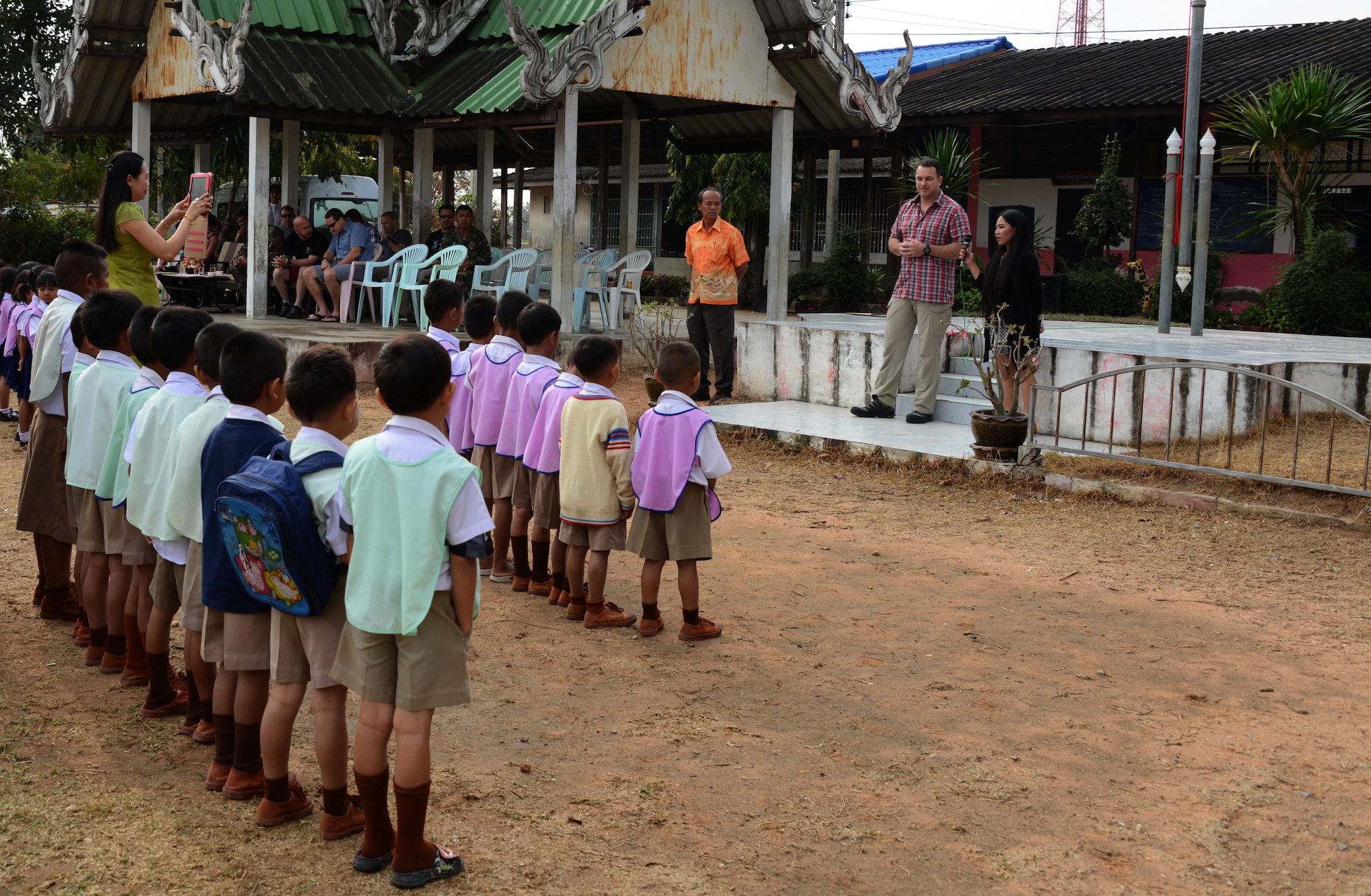 Lt. Col. Edmund Loughran, 320th Special Tactics  Squadron commander, address the children from a school in Nam Phong, Thailand, during a visit Feb. 17, 2015.  During the visit, the group from 320th STS donated sports equipment and spent the morning playing soccer and visiting with the children.  (U.S. Air Force photo by Tech. Sgt. Kristine Dreyer)