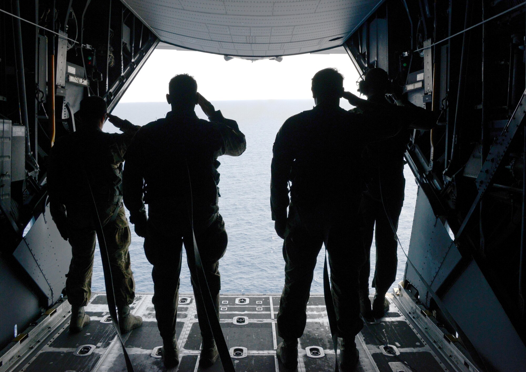 From left, Tech. Sgts Christopher Lugo, Theodore Fioto and Master Sgt. Mark Bunnell, all from the 320th Special Tactics Squadron along with Chief Master Sgt. Mark Peters, 353rd Special Operations Group, pay respects to the crew and passengers of Stray 59 from a MC-130H Combat Talon II off the coast of the Philippines Feb. 26, 2015. The flight is conducted annual to honor those who were lost 34 years ago when a 1st SOS MC-130E, call sign STRAY 59, crashed during an exercise killing eight crew members and 15 passengers. (U. S. Air Force photo by Tech. Sgt. Kristine Dreyer)