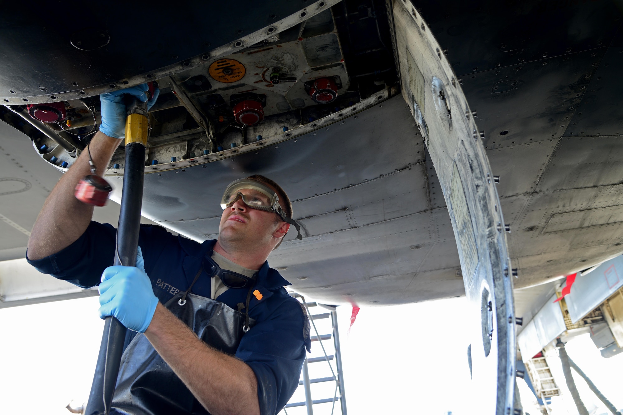U.S. Air Force Senior Airman Cody Patterson, 34th Expeditionary Aircraft Maintenance Unit, hooks up hydraulic mules on a B-1B Lancer, March 1, 2015, at Al Udeid Air Base, Qatar. Patterson, a native of Marion, Va., deployed here from Ellsworth Air Force Base, S.D., is a dedicated crew chief of the 34th Expeditionary Bomb Squadron flagship. Anytime the aircraft's hydraulic systems are ground-operated, a hydraulic mule takes the place of the pumps on the engine to work the aircraft's flight controls, weapons and flaps. (U.S. Air Force photo by Senior Airman Kia Atkins)