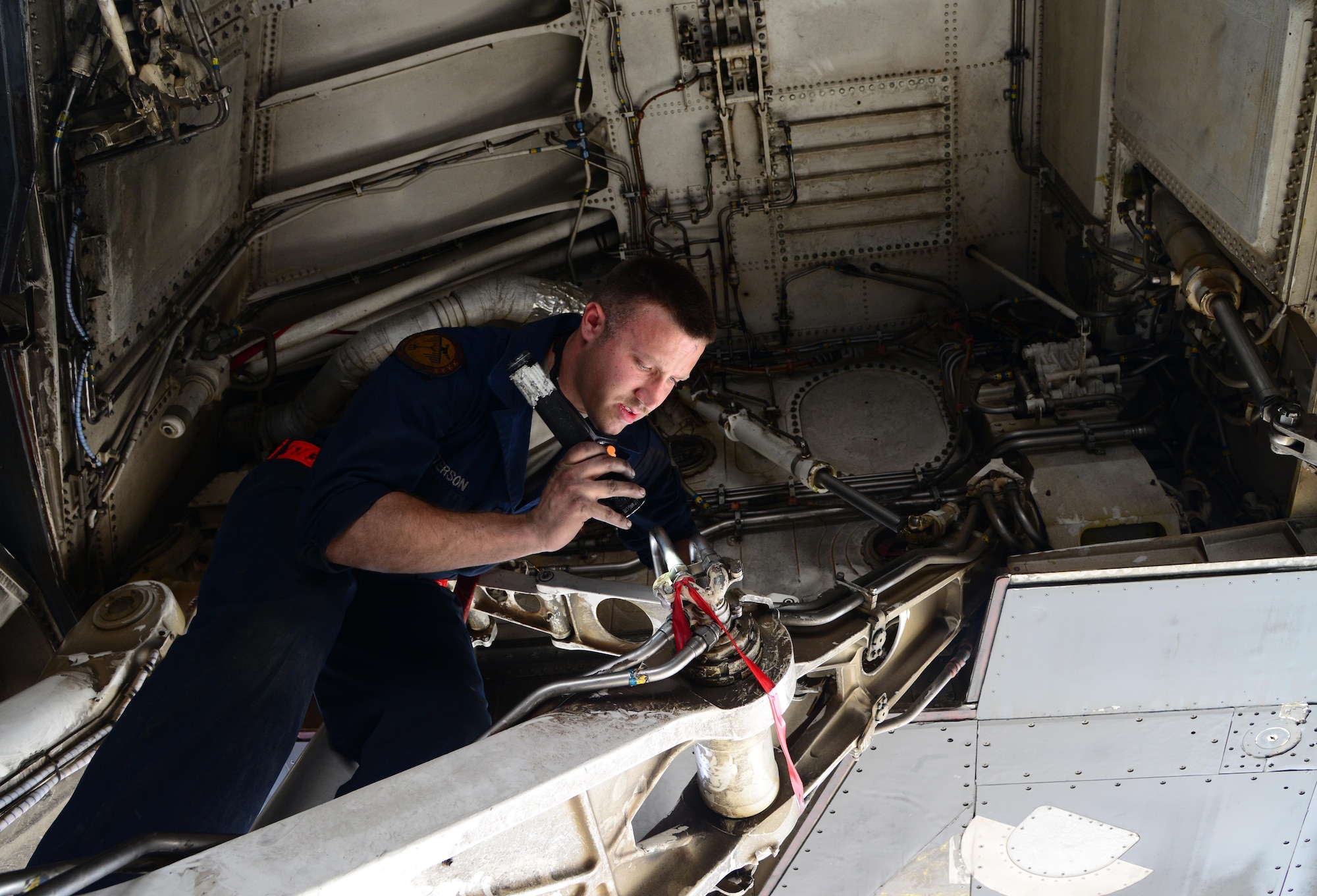 U.S. Air Force Senior Airman Cody Patterson, 34th Expeditionary Aircraft Maintenance Unit, performs a right main landing gear wheel well inspection on a B-1B Lancer, March 1, 2015, at Al Udeid Air Base, Qatar. Patterson, a native of Marion, Va., deployed here from Ellsworth Air Force Base, S.D., is a dedicated crew chief of the 34th Expeditionary Bomb Squadron flagship. Patterson thoroughly checked the wheel well to ensure there was no structural damage. (U.S. Air Force photo by Senior Airman Kia Atkins)