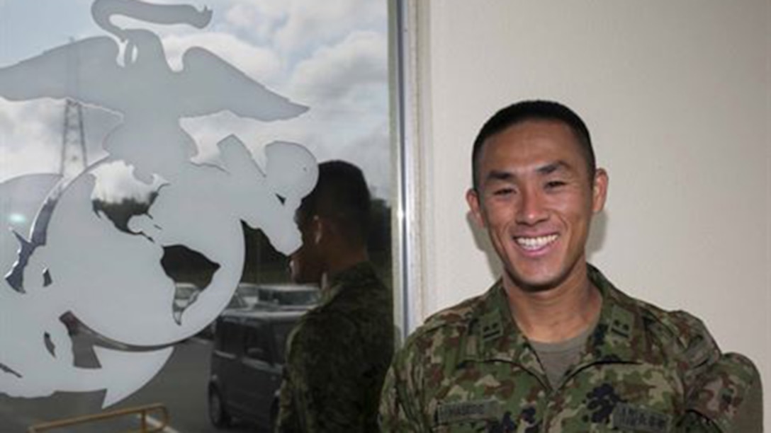 Japanese Ground Self-Defense Force 1st Lt. Ryota Hasebe attached to 3rd Libation 12th Marines, 3rd Marine Division, III Marine Expeditionary Force for two months starting Jan. 11 and ending March 13 poses for a photo aboard Camp Hansen, Okinawa. During those two months Hasebe learned about U.S. Marine Corps artillery and went to Marine Air Ground Combat Center, Twentynine Palms, California for Integrated Training Exercise 2-15. Hasebe, 28, studied Chinese Literature and graduated from Kokugakuin University in Tokyo before joining the JGSDF in 2011. Hasebe is now the battalion fire direction control officer for 1st Battalion, 4th Field Artillery Regiment in Fukuoka Japan.