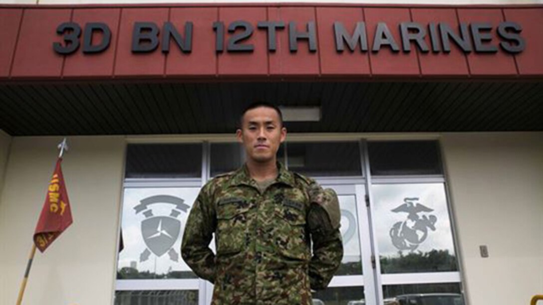 Japanese Ground Self-Defense Force 1st Lt. Ryota Hasebe attached to 3rd Battalion 12th Marines, 3rd Marine Division, III Marine Expeditionary Force for two months starting Jan. 11 and ending March 13 poses for a photo at Camp Hansen, Okinawa. During those two months Hasebe learned about U.S. Marine Corps artillery and went to Marine Air Ground Combat Center Twentynine Palms, California for Integrated Training Exercise 2-15. Hasebe, 28, studied Chinese Literature and graduated from Kokugakuin University in Tokyo before joining the JGSDF in 2011. Hasebe is now the battalion fire direction control officer for 1st Battalion, 4th Field Artillery Regiment in Fukuoka Japan.